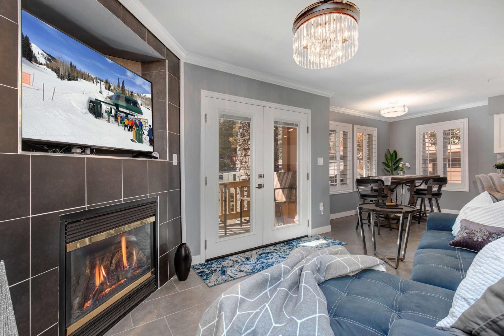 Fox Bay #H101_01: Cozy space with fireplace, sofa set, and access to outdoor patio.