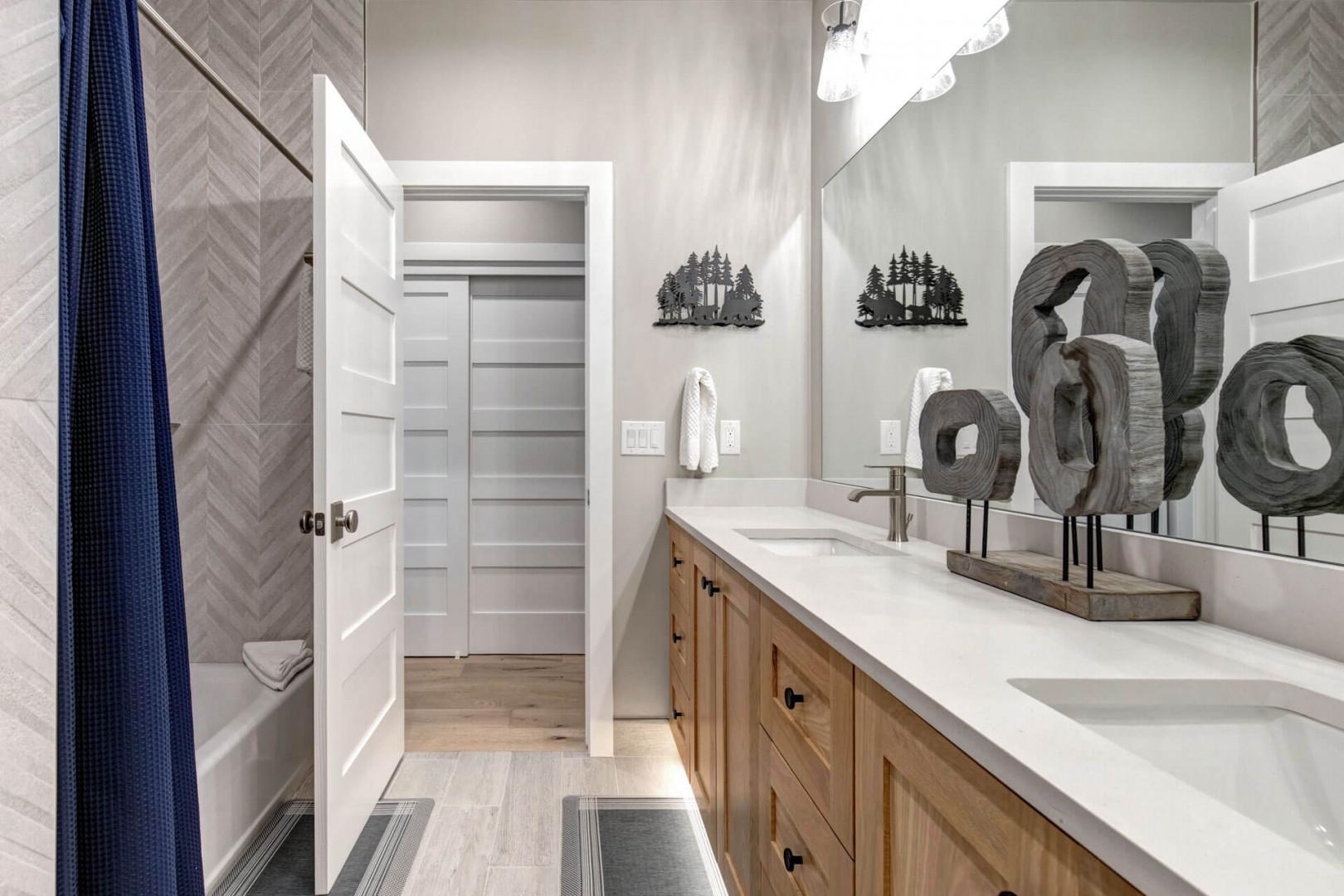 Step into your beautifully appointed bathroom, where modern elegance meets rustic warmth. Dual vanities and ample storage ensure your morning routine feels effortless and serene.