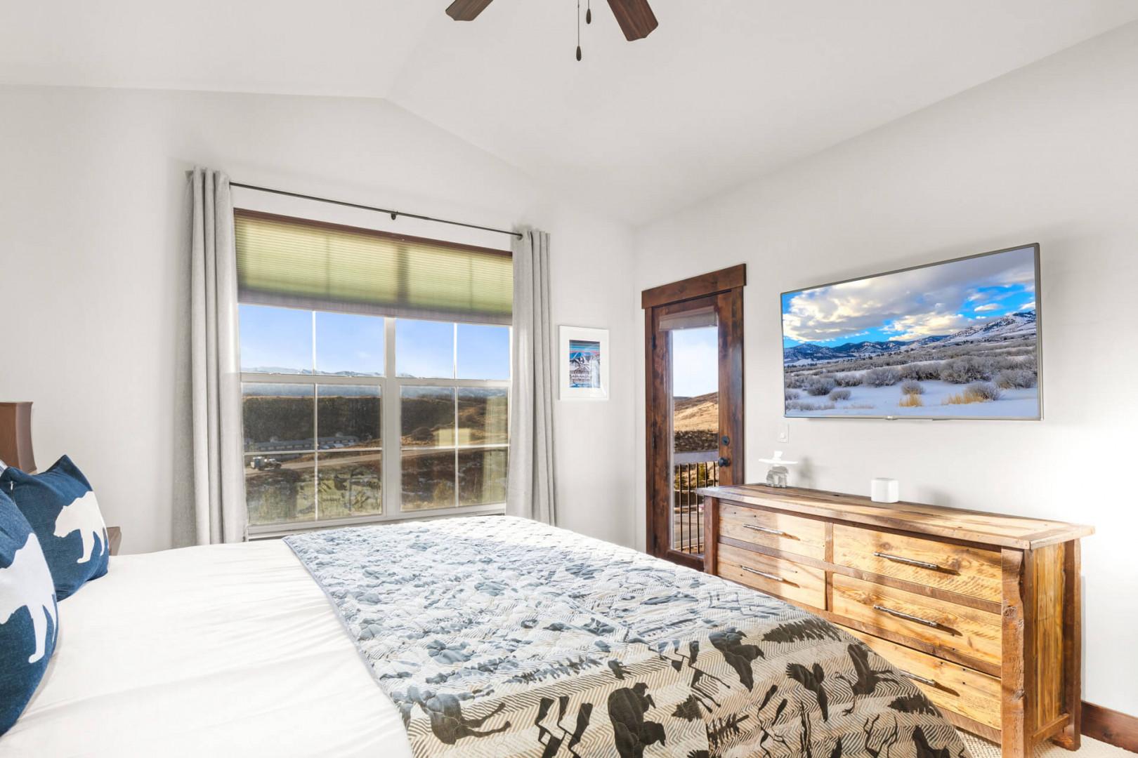 Wake up to stunning mountain views from your comfortable bed, with a ceiling fan overhead and spacious dresser for your belongings.