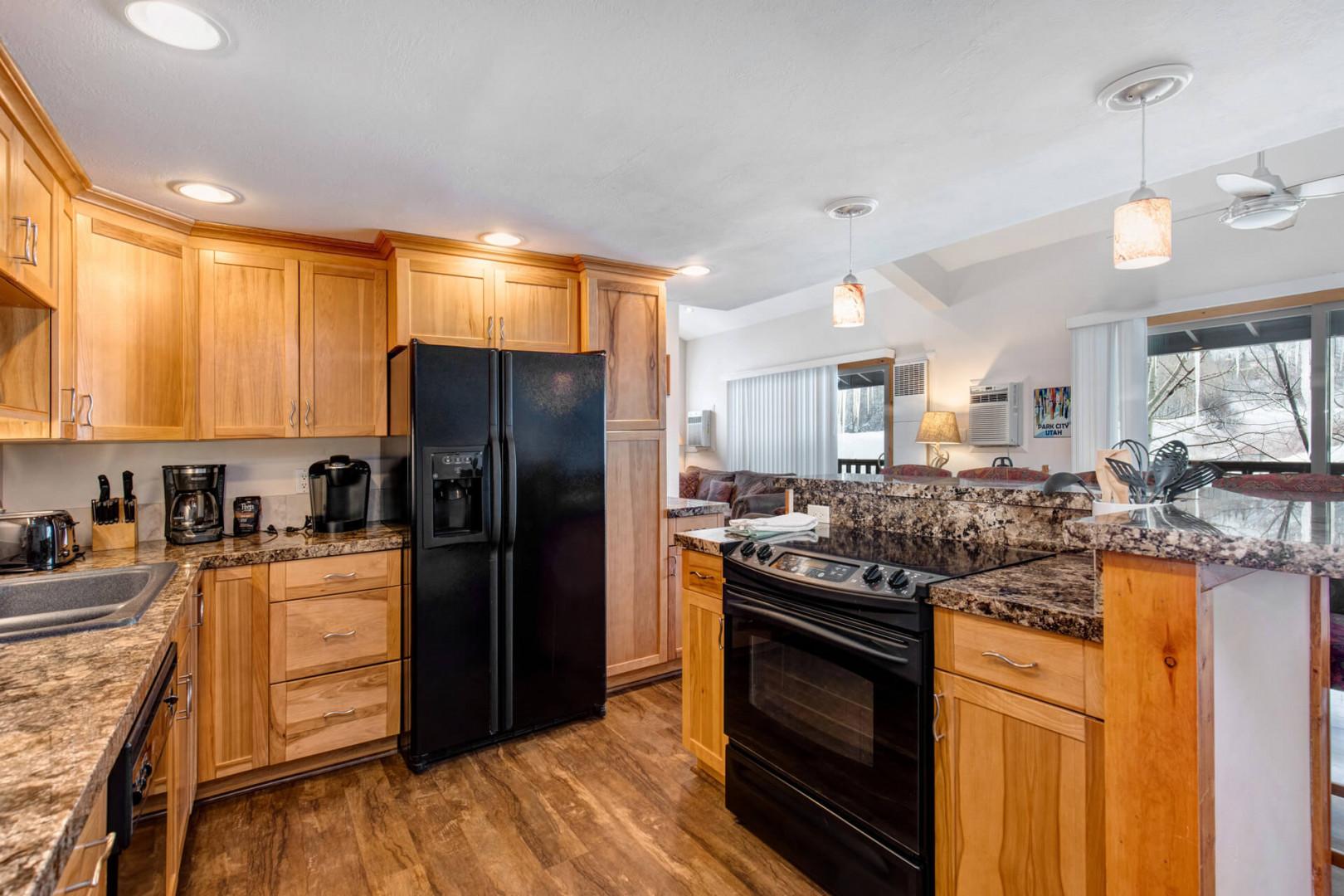 Fully Equipped Kitchen: "Modern amenities in a spacious kitchen with wood cabinets and appliances."