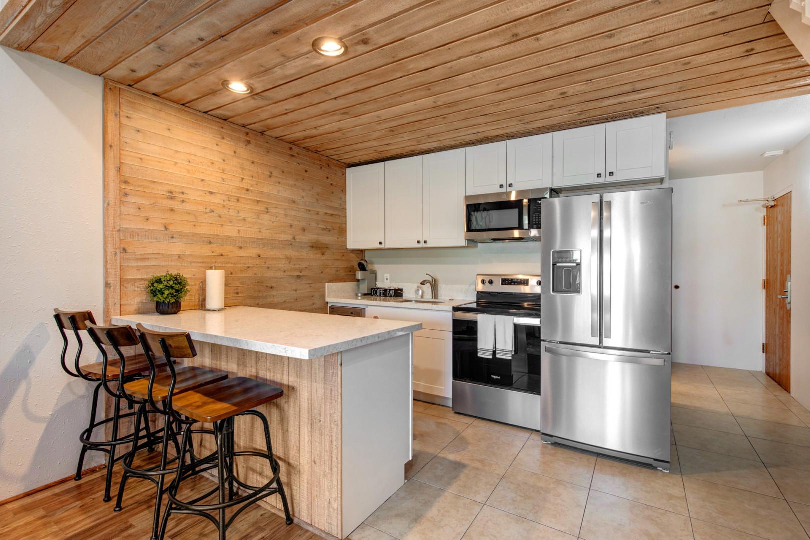 Bar stools at the kitchen top with a view of the area.