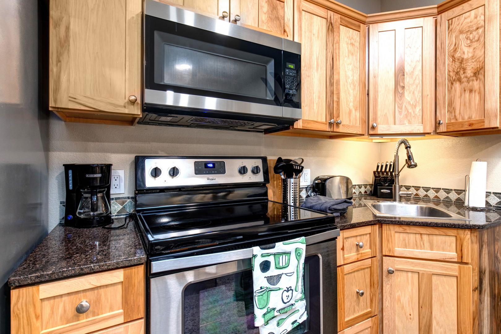 Kitchen: "Fully equipped with electric range, microwave, coffee maker, toaster, and sink."