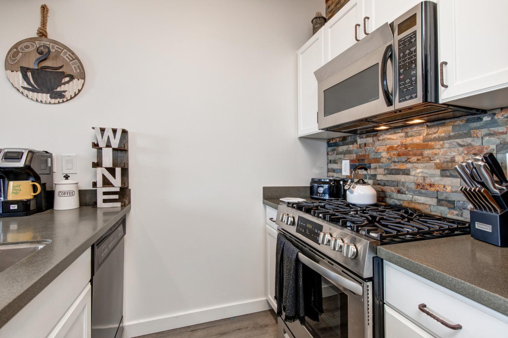 The Mason at Stillwater 7072: Modern appliances and ample storage in sleek kitchen design.