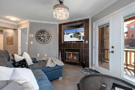 Cozy space with a fireplace and outdoor patio for relaxation.