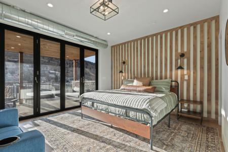 Vacation Rentals in Park City at Upper Main 237: Primary King suite - patio access and cozy sofa chair