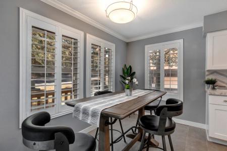 Dining table: "Sunlight streams through windows, illuminating the elegant dining table."
