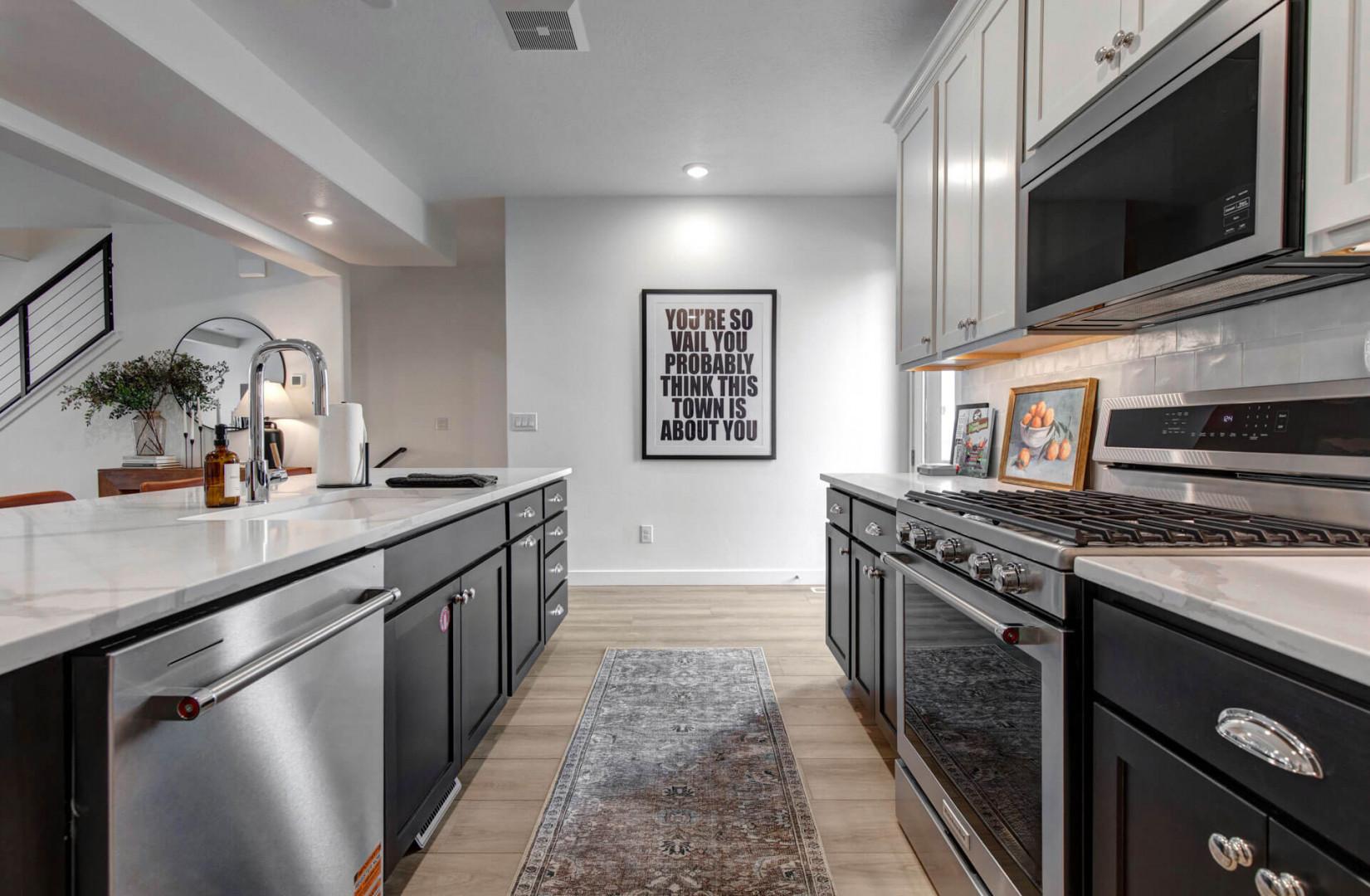Cook your favorite meals in this stylish galley kitchen featuring stainless steel appliances and elegant countertops.
