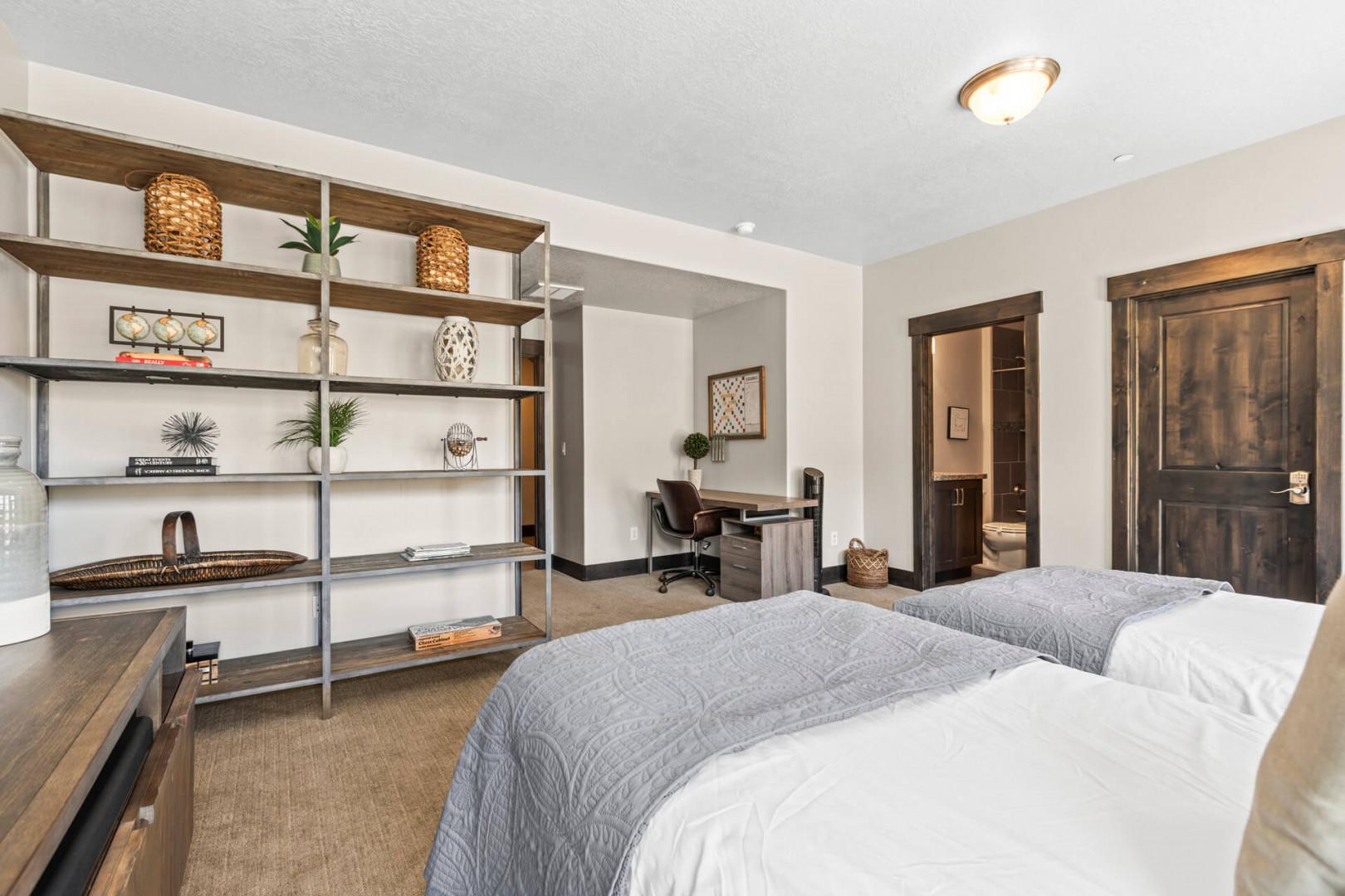 Settle into your stylish bedroom with twin beds, modern workspace, and thoughtful storage—perfect for rest and productivity.