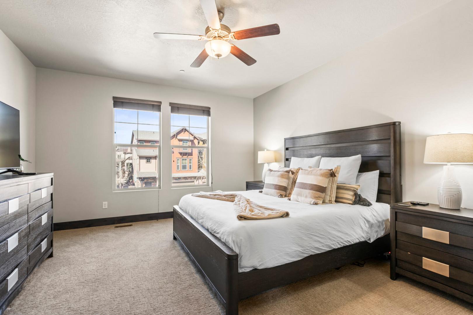 Drift off in your cozy bedroom with plush bedding and a gentle ceiling fan keeping you comfortable all night long.