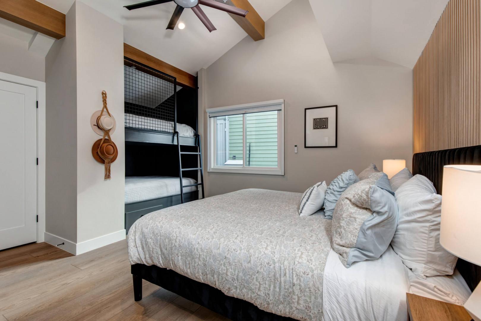 Upper Main 301: Rest in your stylish bedroom featuring exposed beams, built-in bunks, and modern comfort for the perfect family retreat.