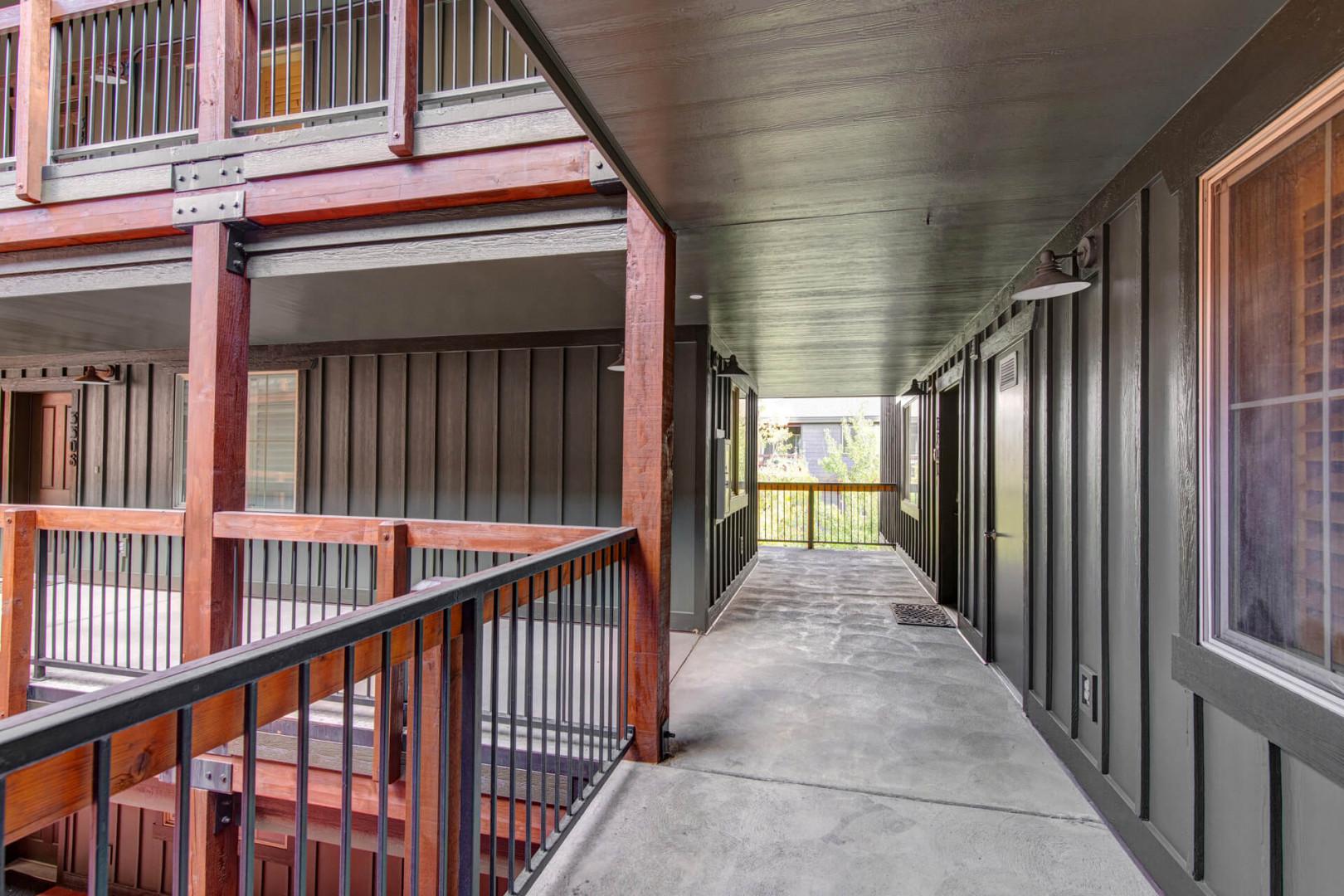 Modern architectural design features exposed beams and corrugated metal accents, creating a contemporary industrial aesthetic throughout the property's shared spaces.