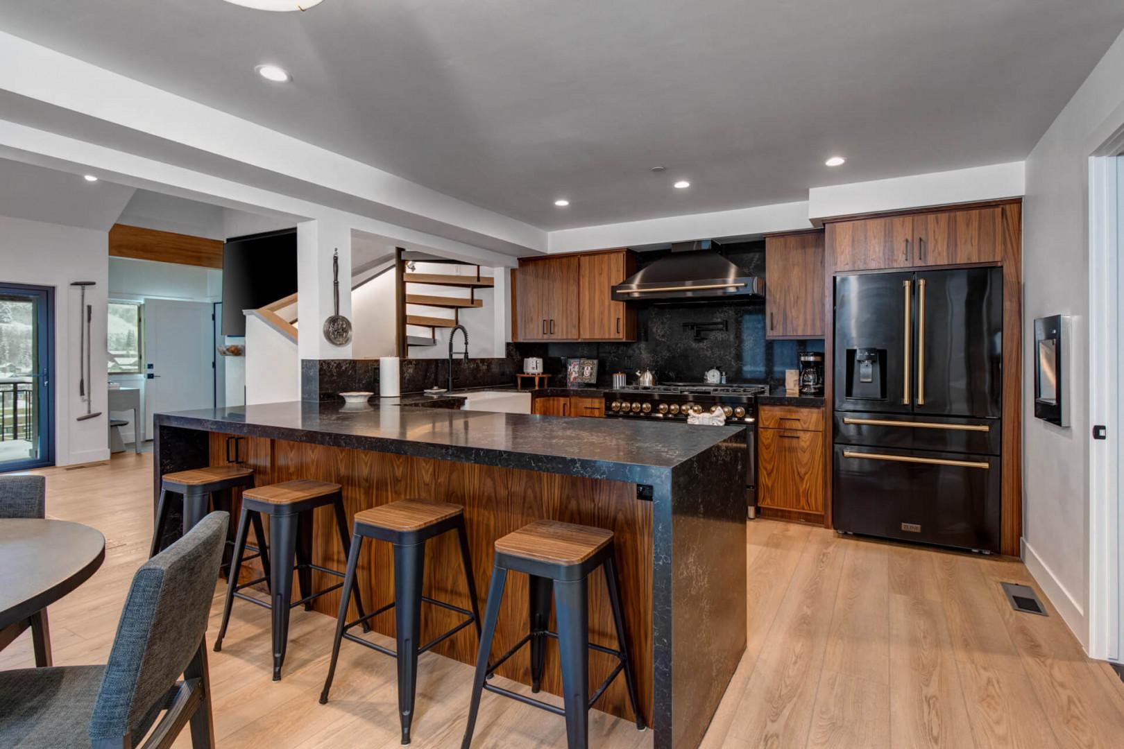 Upper Main 301: Your gourmet kitchen awaits with rich wood cabinetry, sleek granite counters, and stainless steel appliances perfect for culinary adventures together.