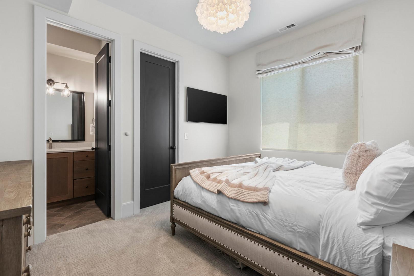 Sink into plush bedding under a statement chandelier, with your own ensuite bathroom steps away and a wall-mounted TV for lazy mornings in.
