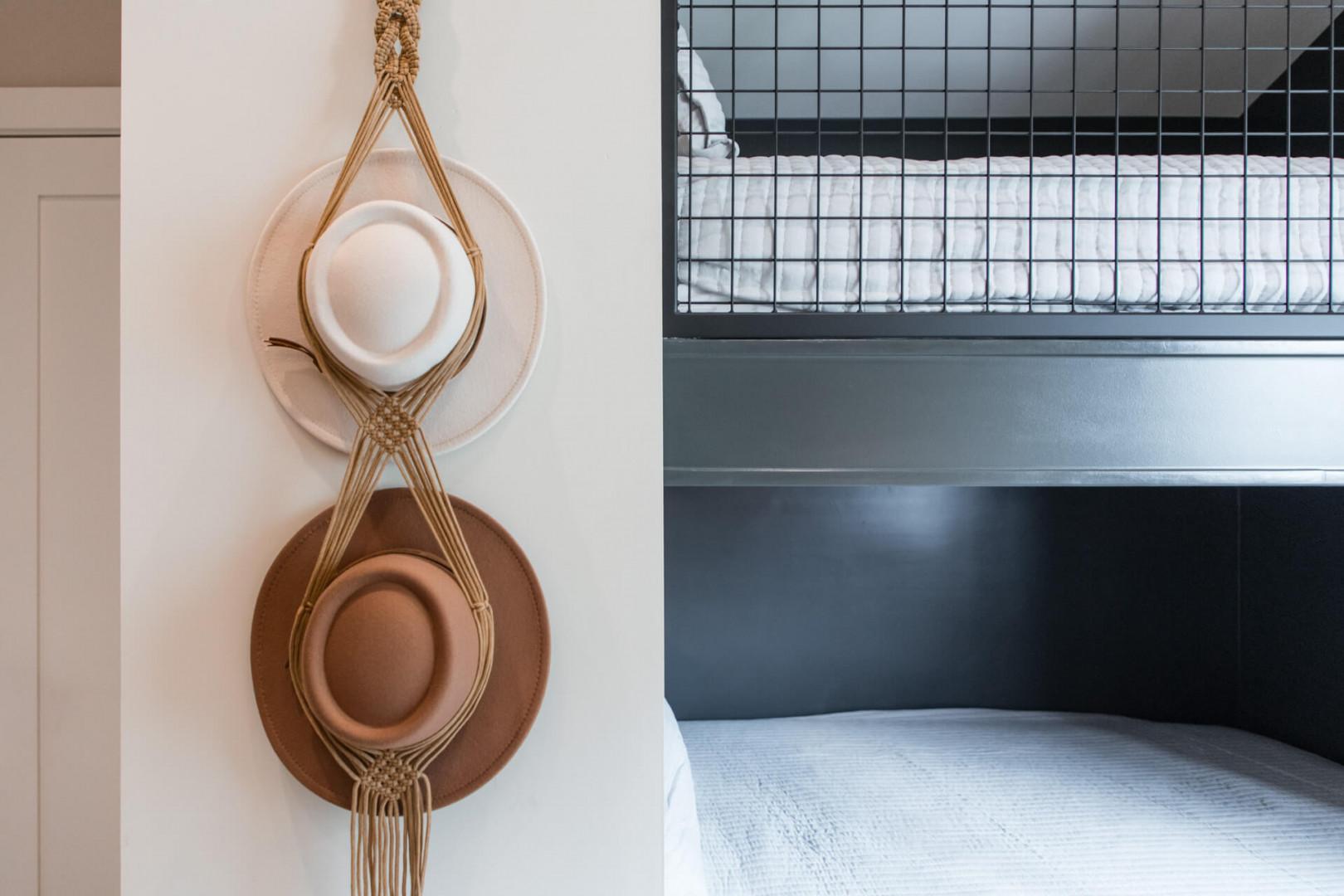 Upper Main 301: Cozy touches await in your bedroom, where thoughtful details like handwoven hat holders create a warm, personalized retreat.