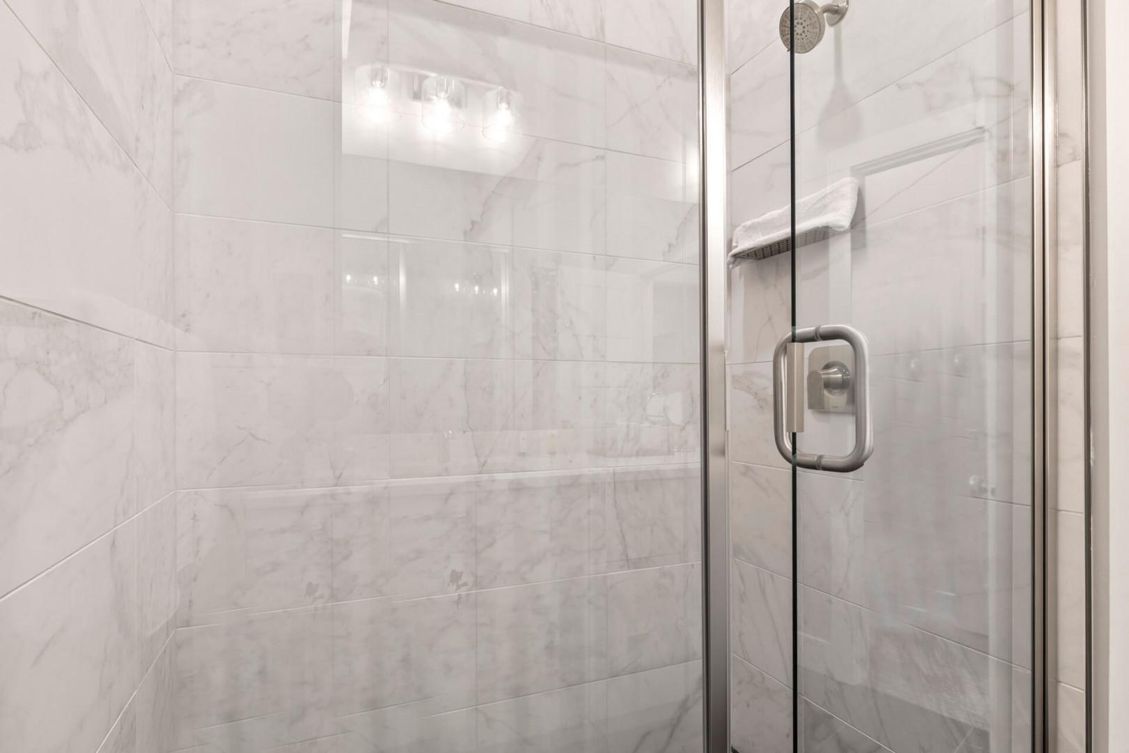 Mayflower Lakeside 301-45: Modern shower with sleek glass enclosure, a perfect oasis for relaxation.