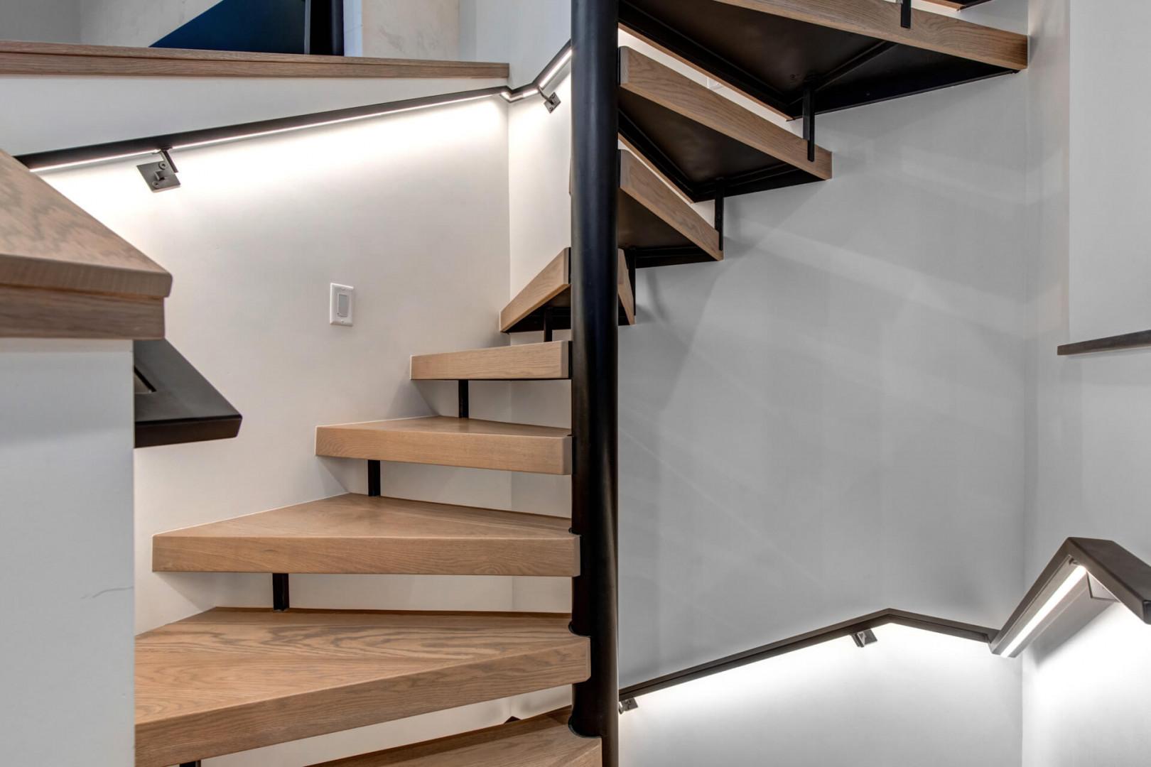 Ascend the stunning floating staircase with its sleek wood treads and modern steel frame—your gateway to the upper level awaits.