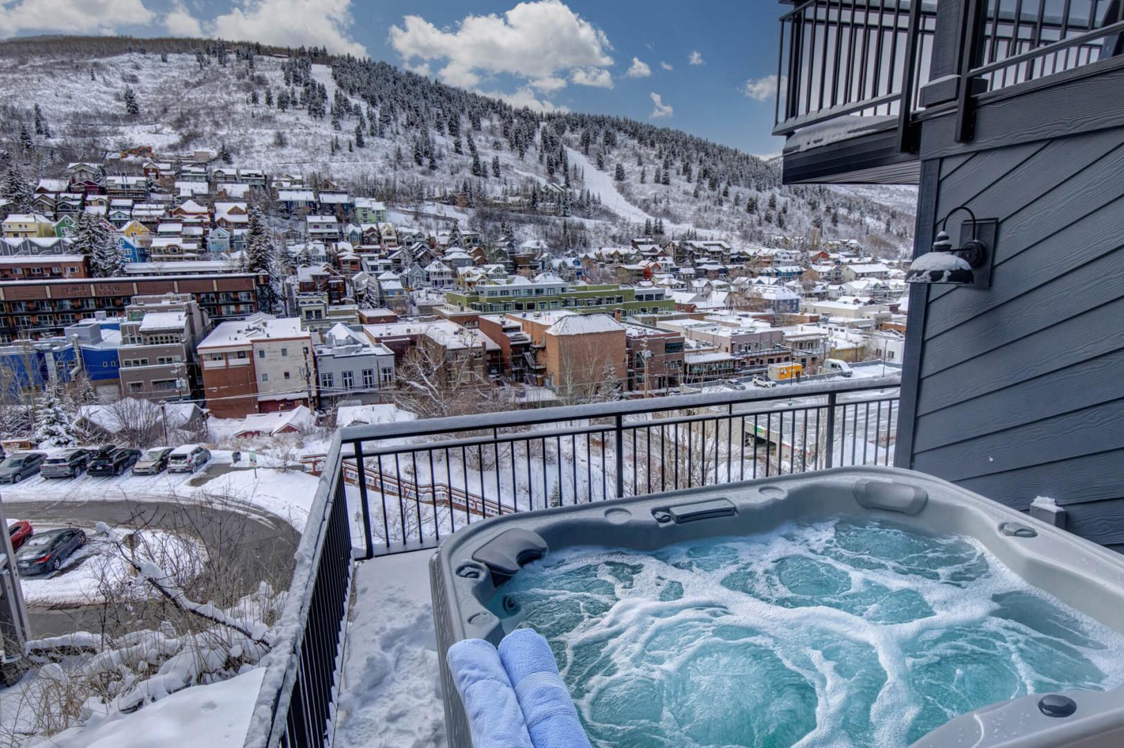 Upper Main 301: Soak in the bubbling hot tub while snow-capped mountains create a breathtaking backdrop for your winter mountain getaway.