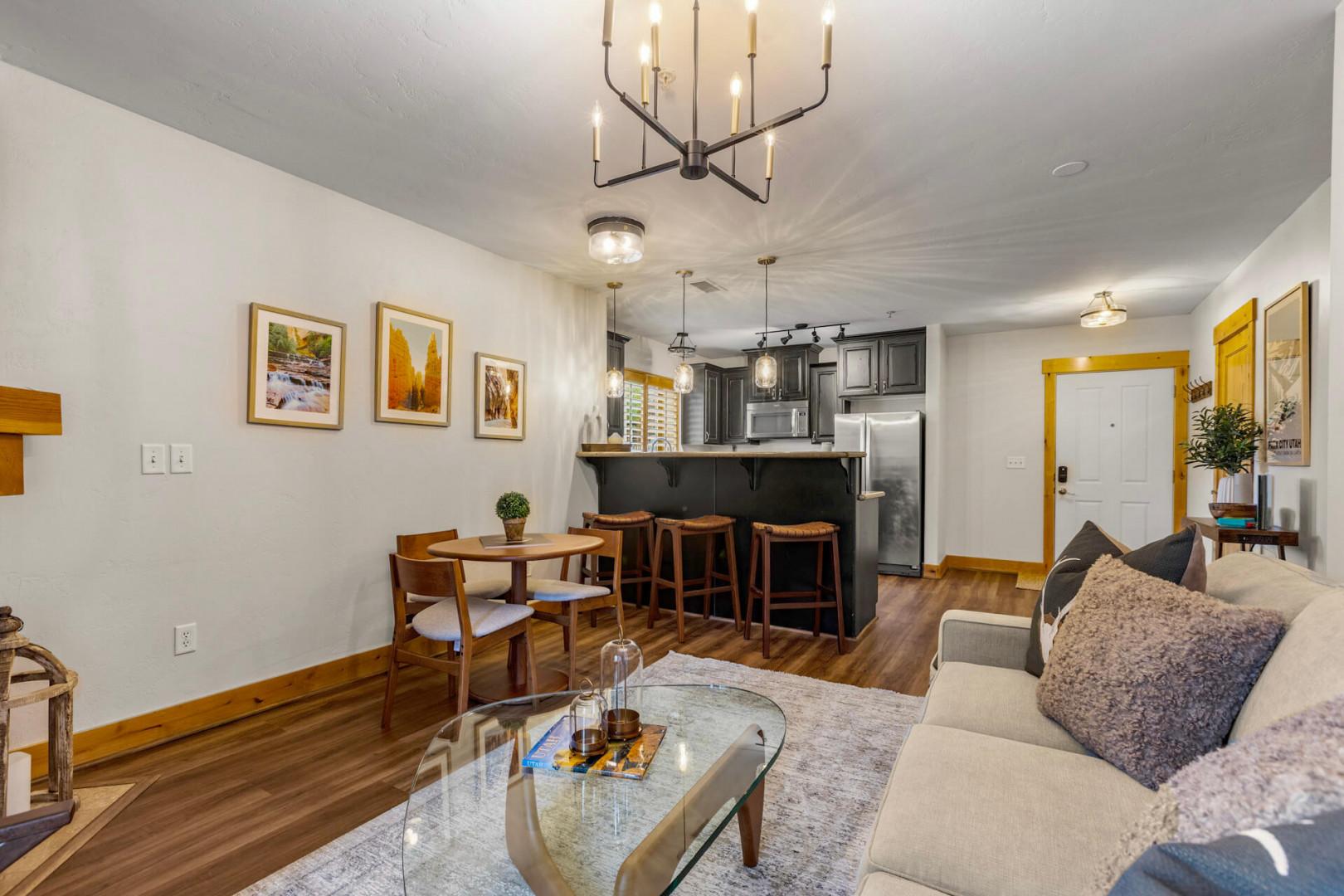Unwind in your cozy open-concept living space, where warm wood accents and comfortable seating invite you to relax after exploring. The fully-equipped kitchen and dining area make it easy to enjoy meals together.