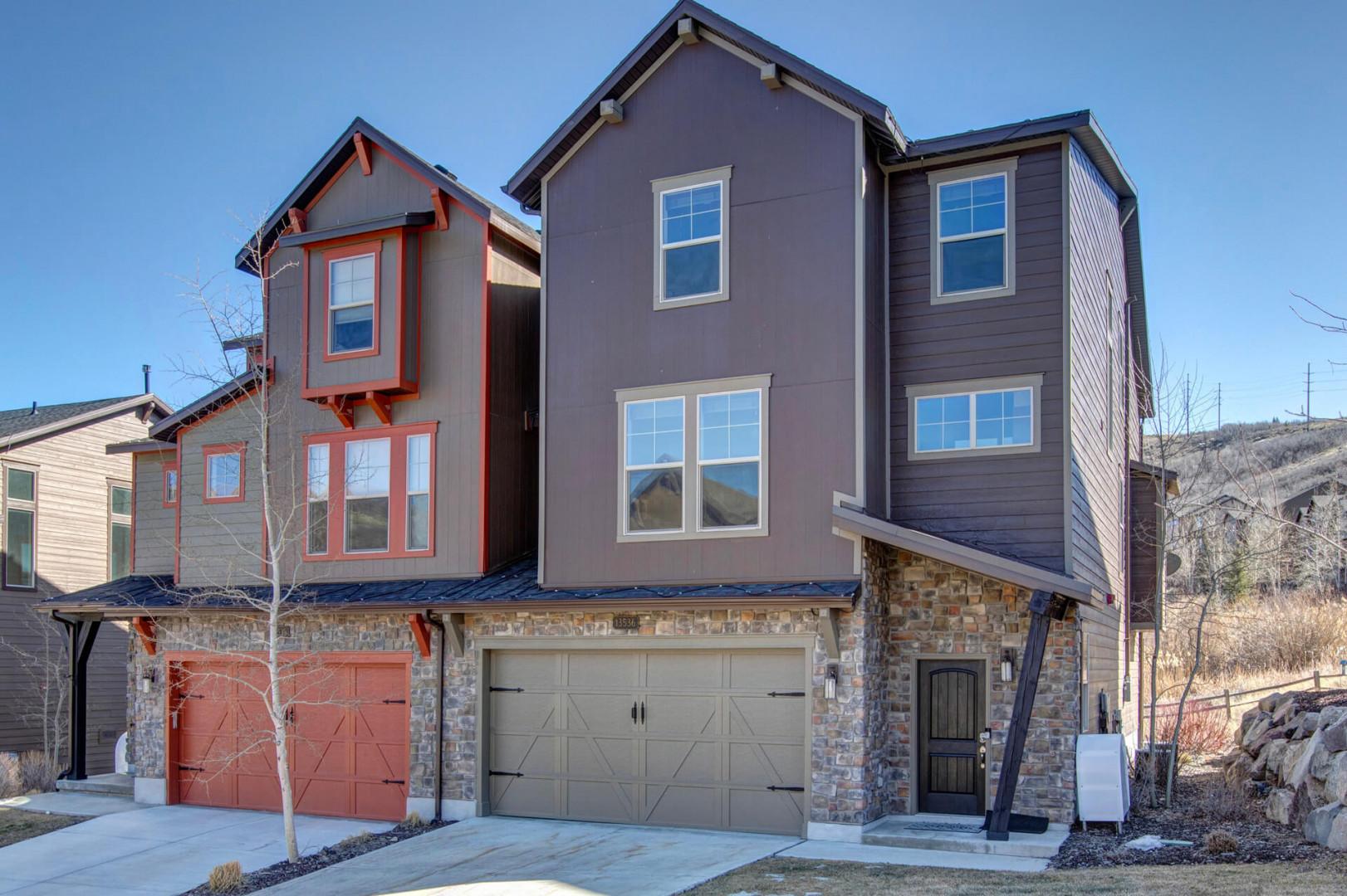 Modern townhomes with mountain views and attached garages create a welcoming neighborhood setting.
