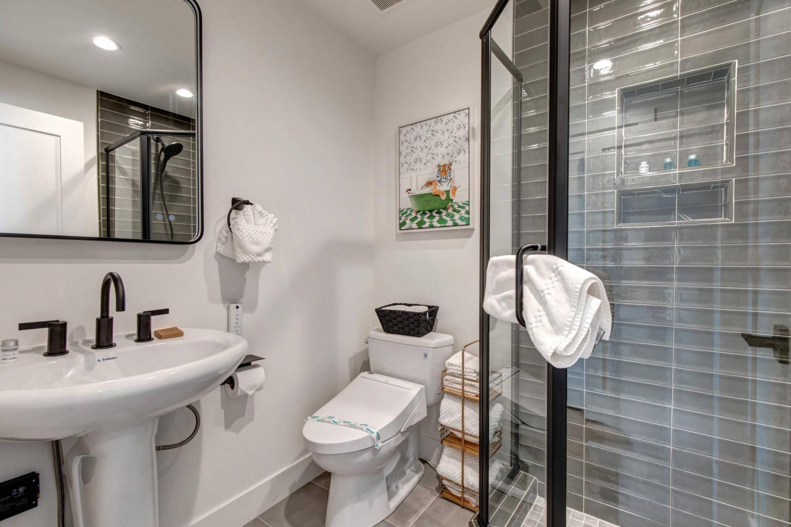Upper Main 301: Refresh in your modern bathroom with sleek subway tile shower, contemporary fixtures, and thoughtful touches like fluffy towels waiting for you.