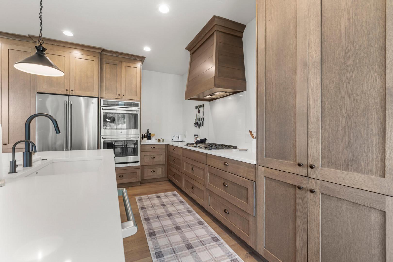 Your spacious gourmet kitchen features warm wood cabinetry, stainless steel appliances, and plenty of counter space for preparing meals together during your stay.