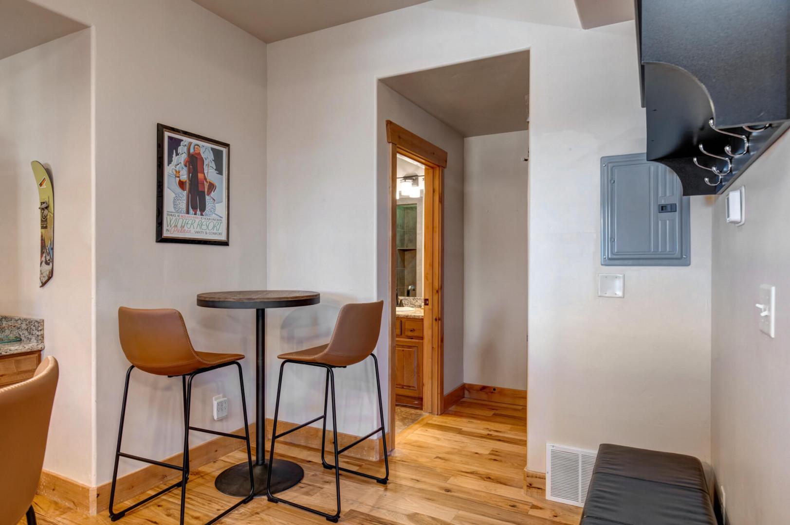 Enjoy your morning coffee at this stylish bistro table, perfectly positioned near the kitchen for convenient dining.