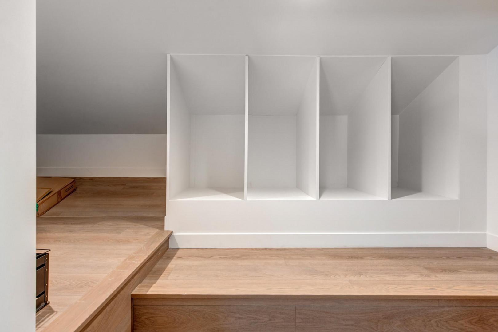 Your built-in storage keeps belongings organized in this clean, modern space with warm wood flooring.