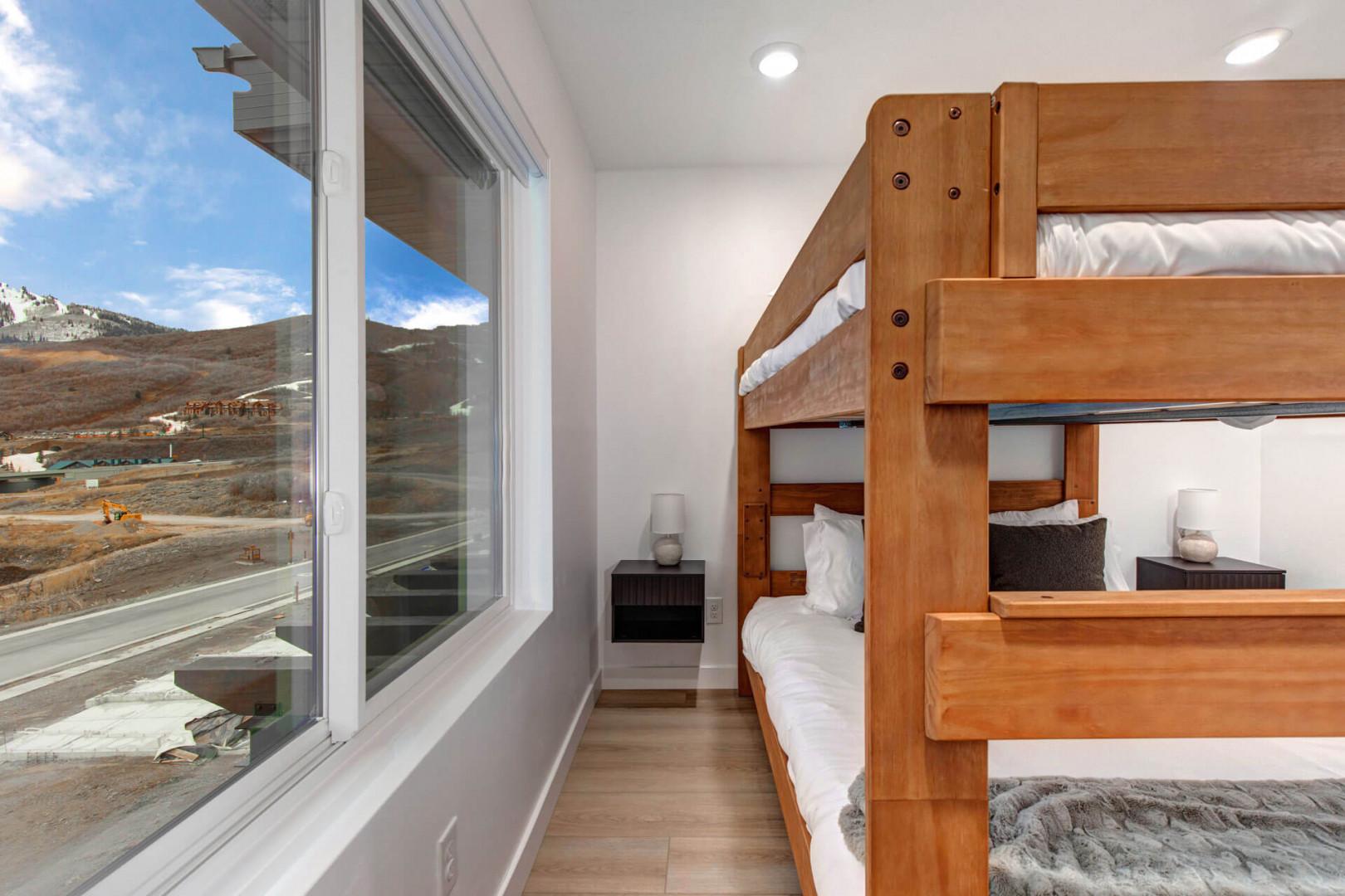 Drift off to sleep in your cozy bunk bed while gazing out at stunning mountain views through floor-to-ceiling windows.