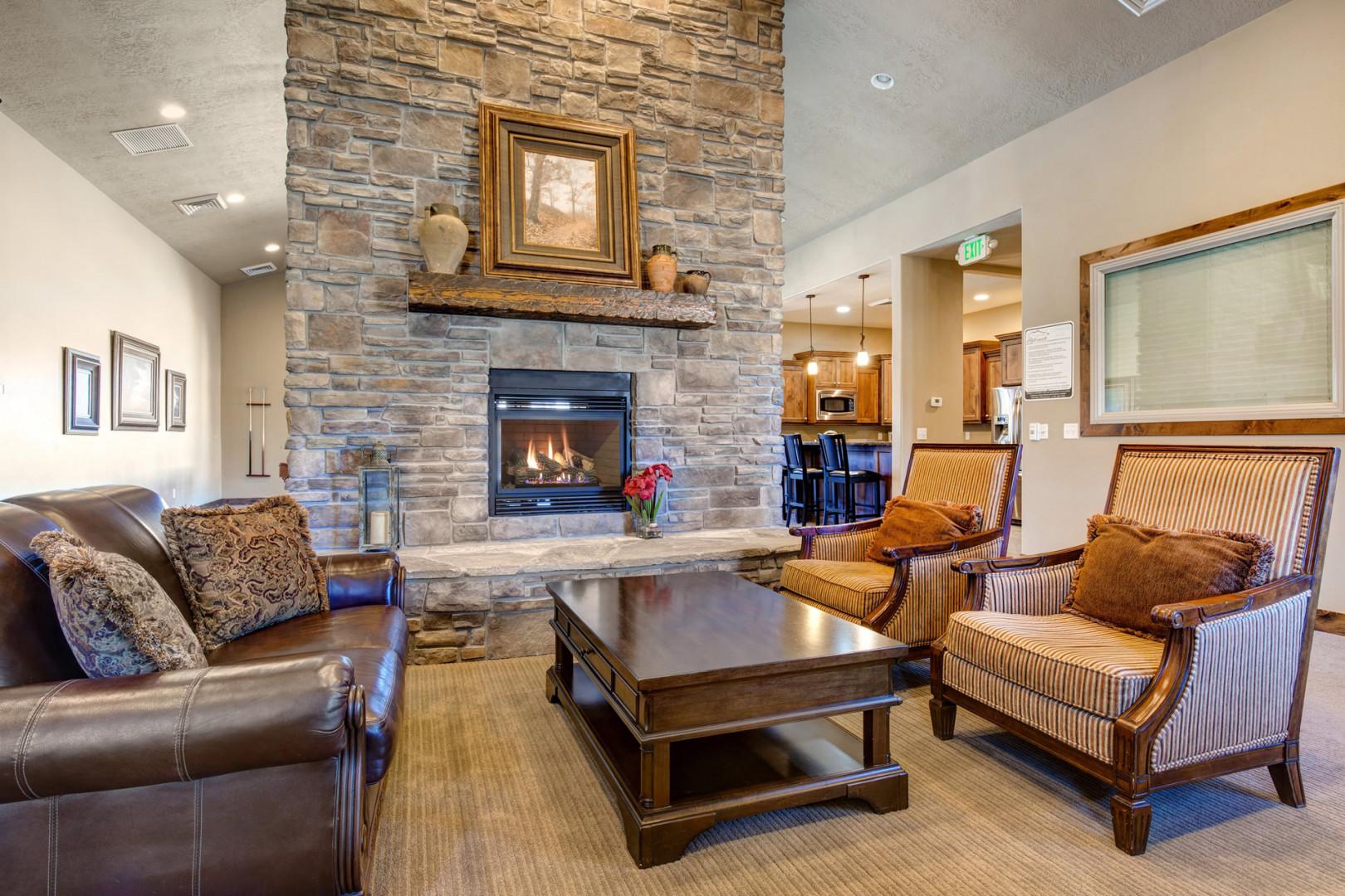 Settle into plush seating by the stone fireplace, where vaulted ceilings and warm wood accents create your perfect retreat for cozy evenings together.