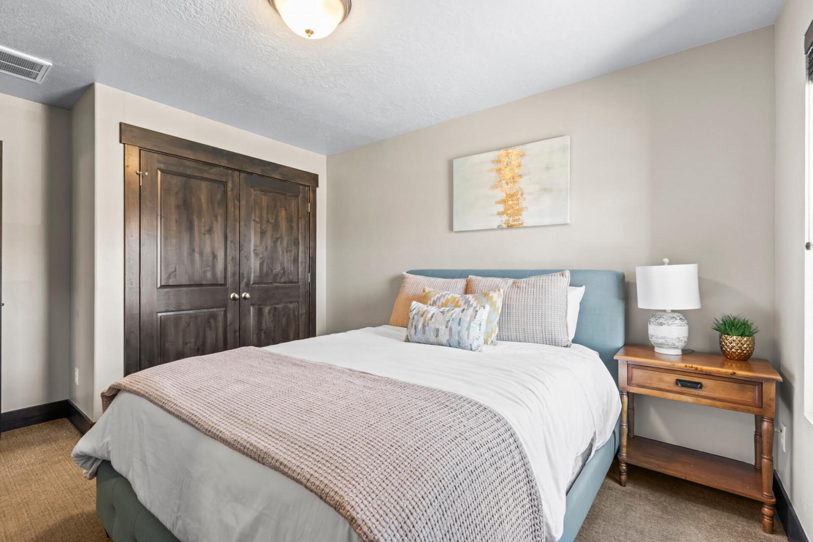 Drift into peaceful sleep in your cozy bedroom, featuring plush bedding, warm wood accents, and thoughtful touches that create the perfect retreat.