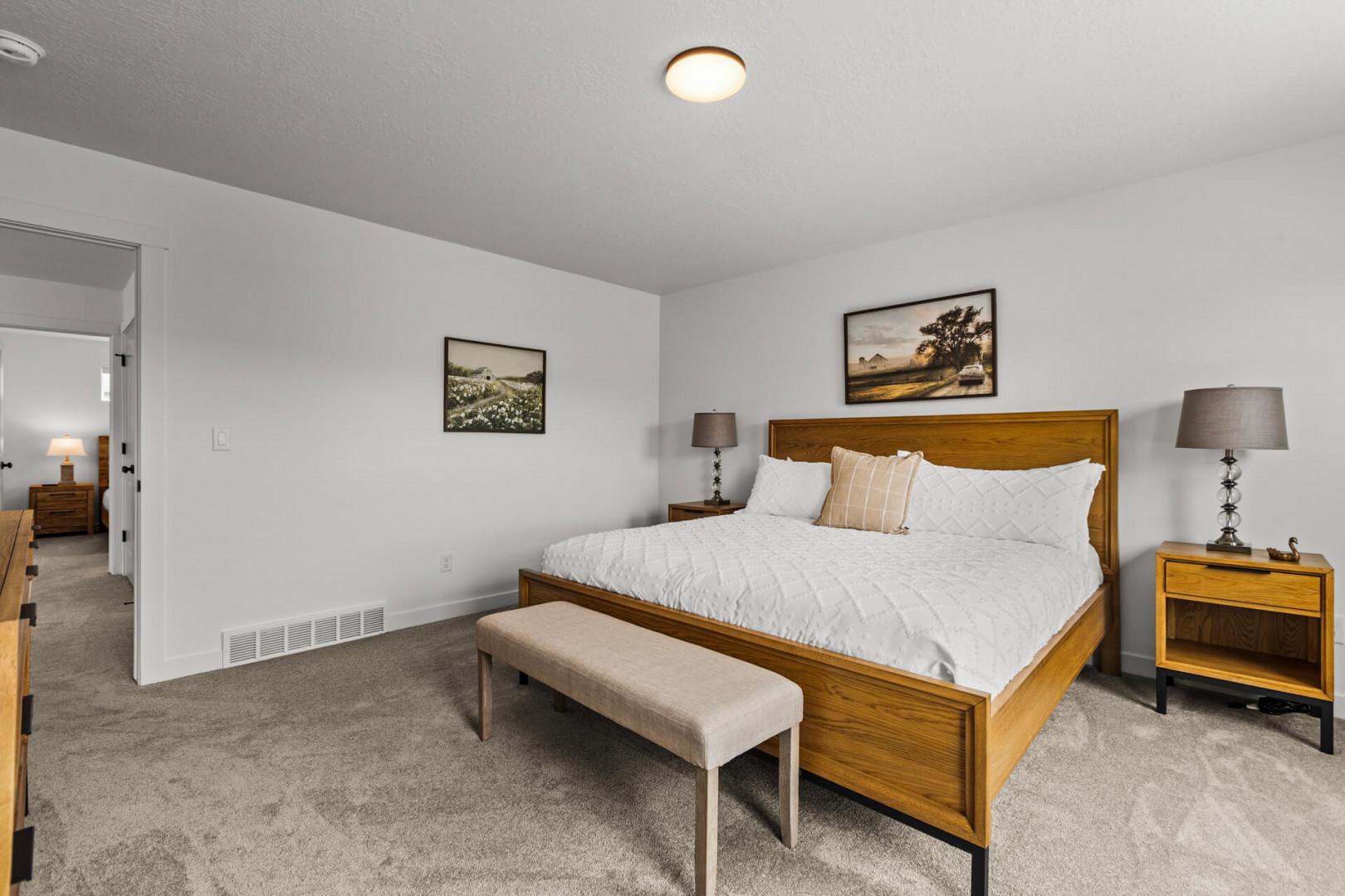 Settle into your peaceful bedroom sanctuary with crisp white linens and warm wood accents creating the perfect retreat for restful nights.