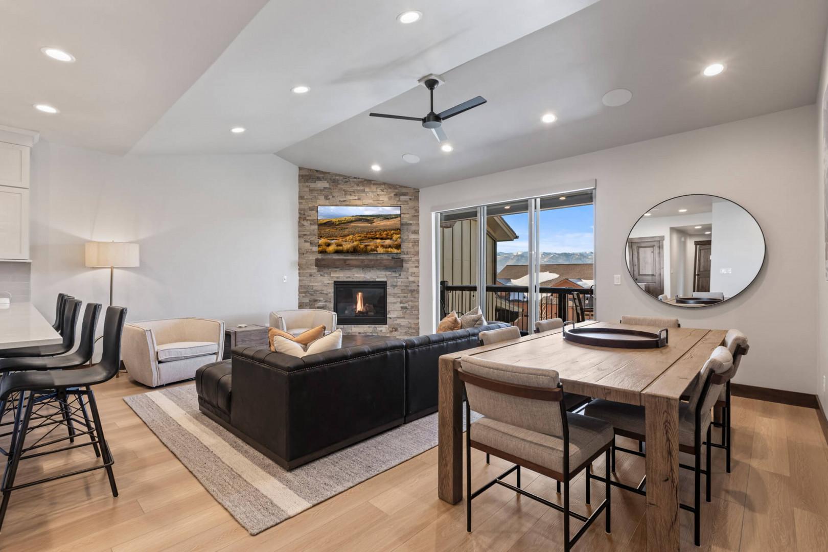 Black Rock Ridge 14536: Cozy space with fireplace, dining table outdoor access, perfect for relaxation.