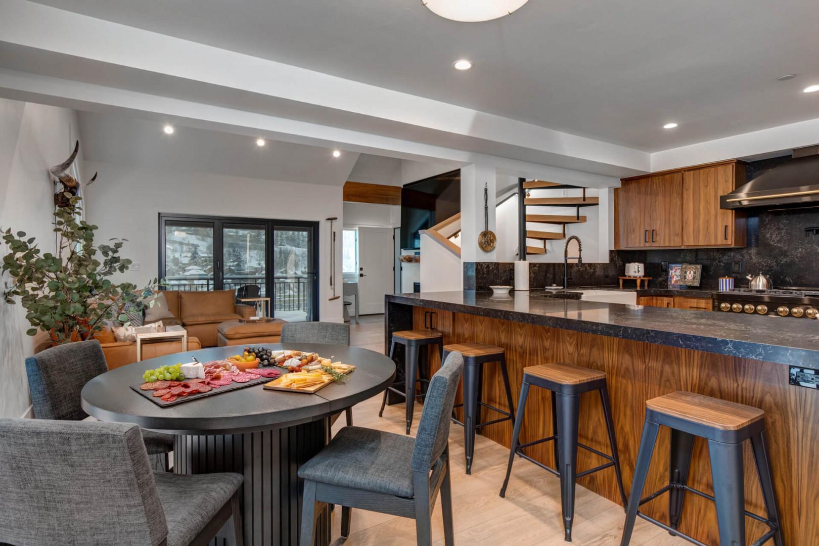 Upper Main 301: Gather around your modern kitchen island where warm wood meets sleek design, perfect for sharing charcuterie and creating memories.