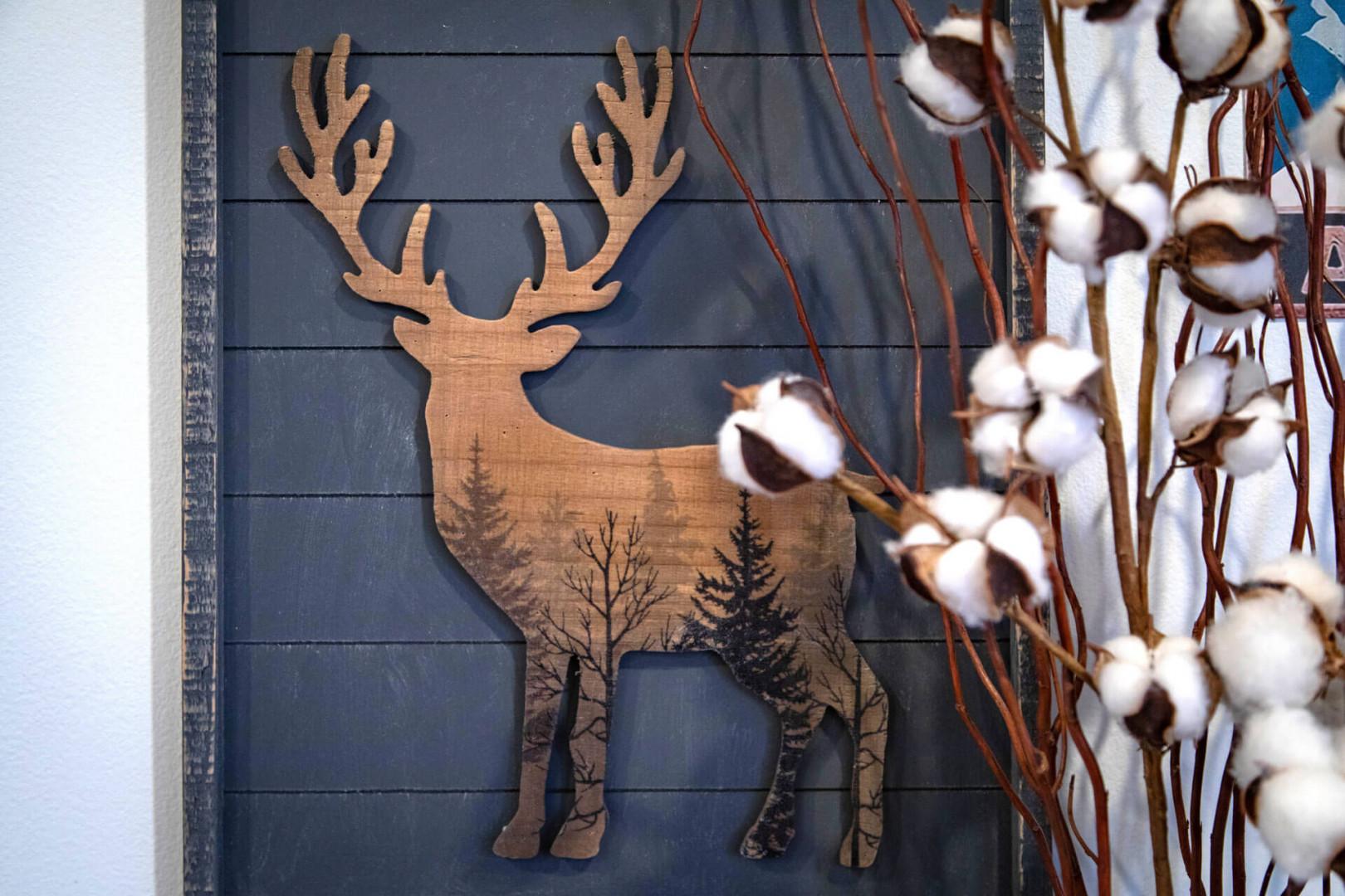 Rustic charm welcomes you with handcrafted woodland art and soft cotton stems that create your perfect cozy retreat atmosphere.