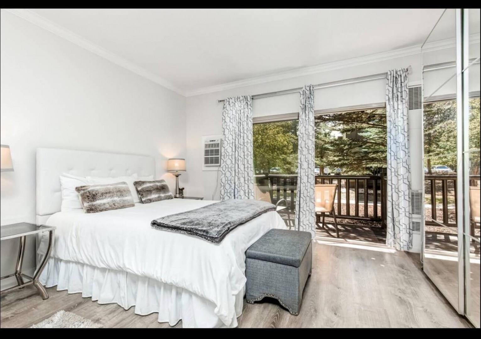 Wake up refreshed in your airy bedroom, where natural light filters through elegant curtains and sliding doors open to your private balcony retreat.