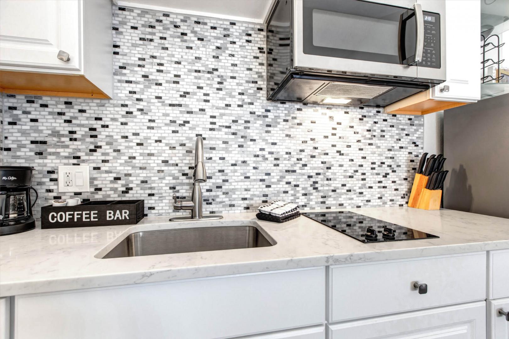 Create culinary memories in your fully equipped kitchen with sleek marble counters, modern appliances, and a charming coffee bar for morning rituals.