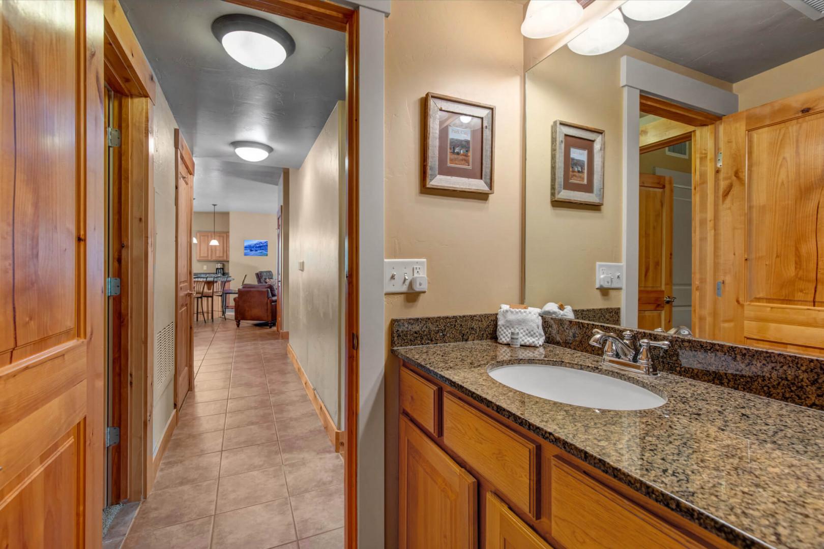 Refresh in your private vanity area, complete with granite counters, warm wood cabinetry, and plush towels ready for your arrival.