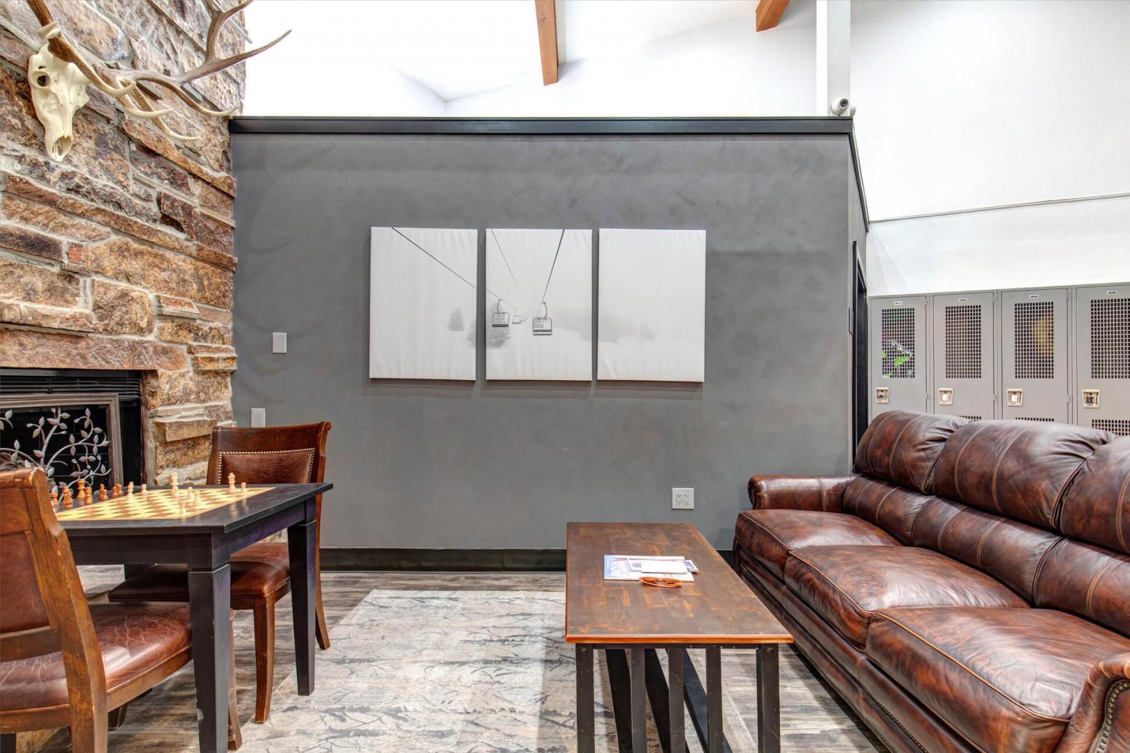 Settle in for a cozy evening in this inviting living space, where rustic brick and leather furnishings create a warm mountain lodge feel. Challenge your travel companions to a game of chess by the fireplace.