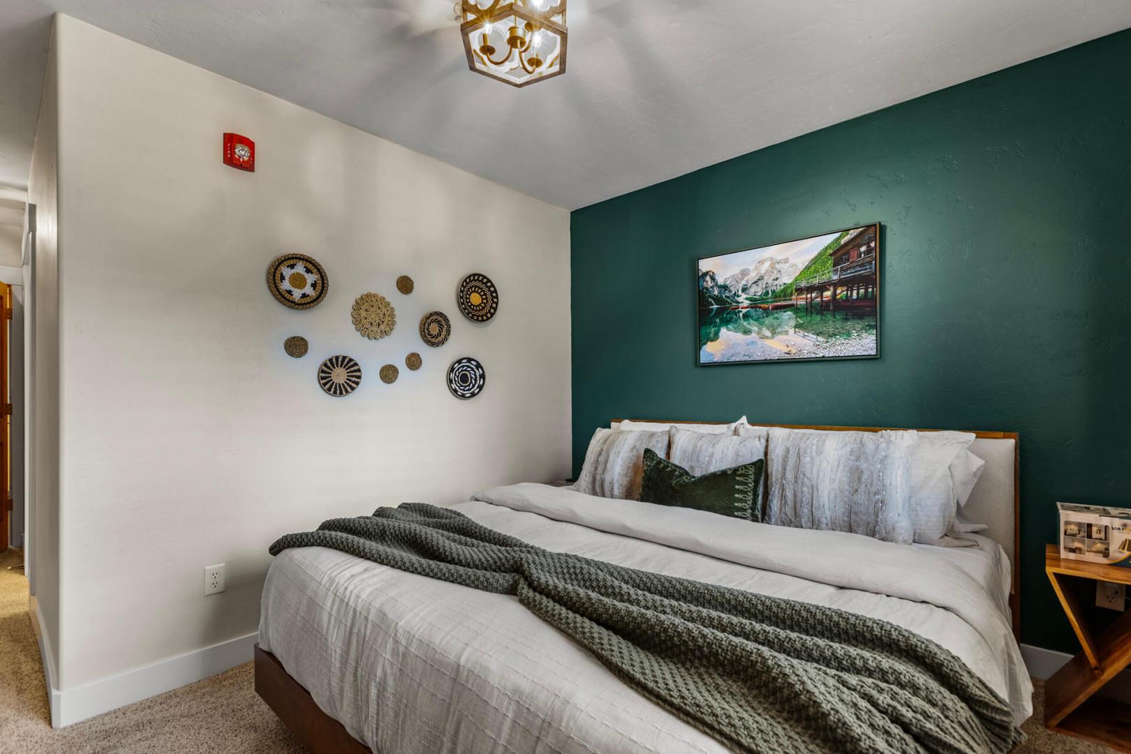 Sink into crisp linens on your plush king bed, surrounded by soothing earth tones and artful touches that invite you to unwind and recharge.