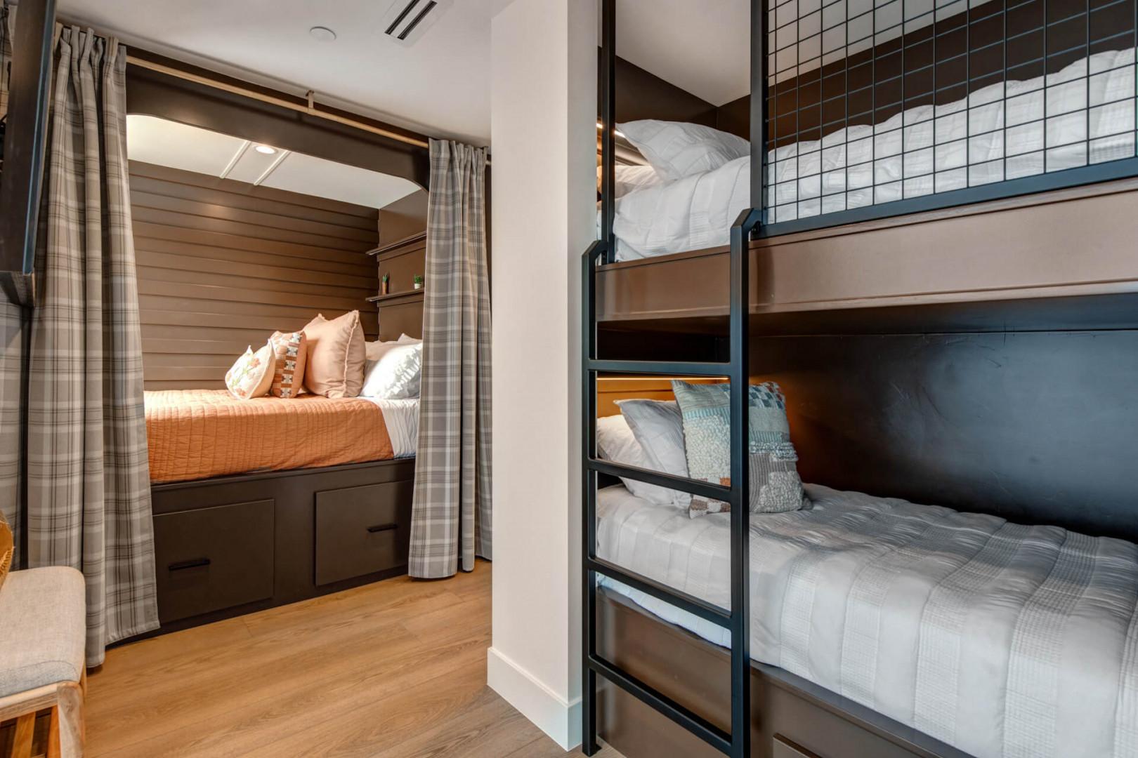Upper Main 301: Cozy bunk beds and built-in sleeping nooks create your perfect family retreat with plaid curtains and soft linens.