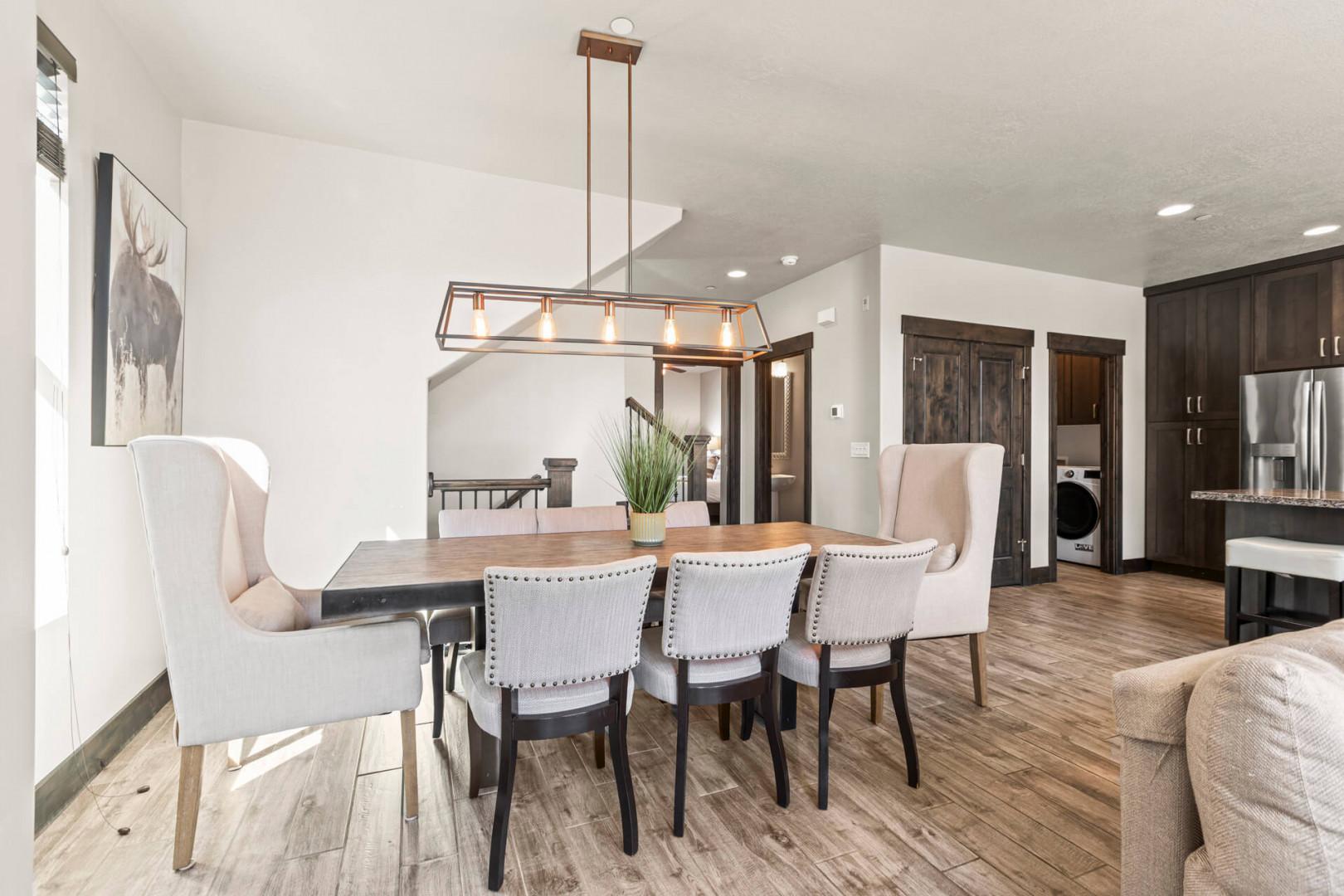 Gather around this elegant dining table for meals, conversation, and making memories. Soft lighting, stylish seating, and open design connect you to the kitchen and living areas.
