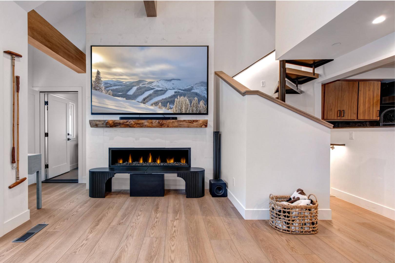 Upper Main 301: Cozy up by your modern fireplace while watching the big screen TV in this stylish living space with warm wood accents.