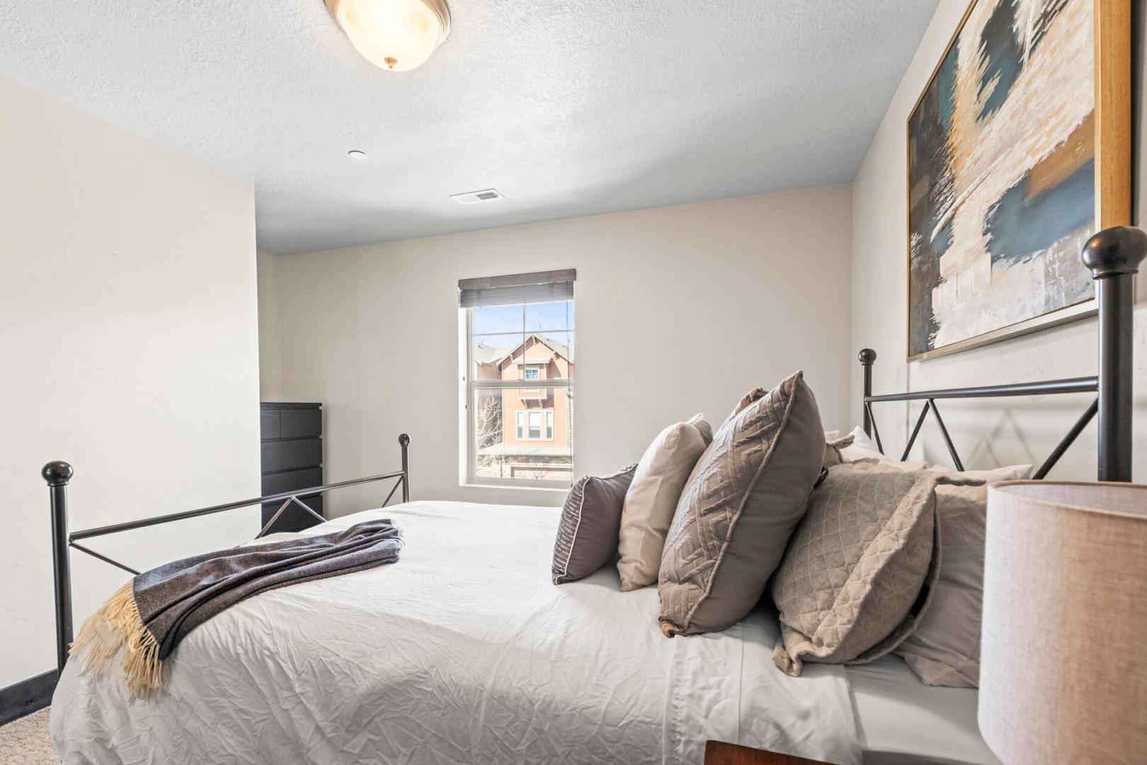 Sink into crisp linens and plush pillows in your serene bedroom retreat, where soft natural light creates the perfect atmosphere for rest.
