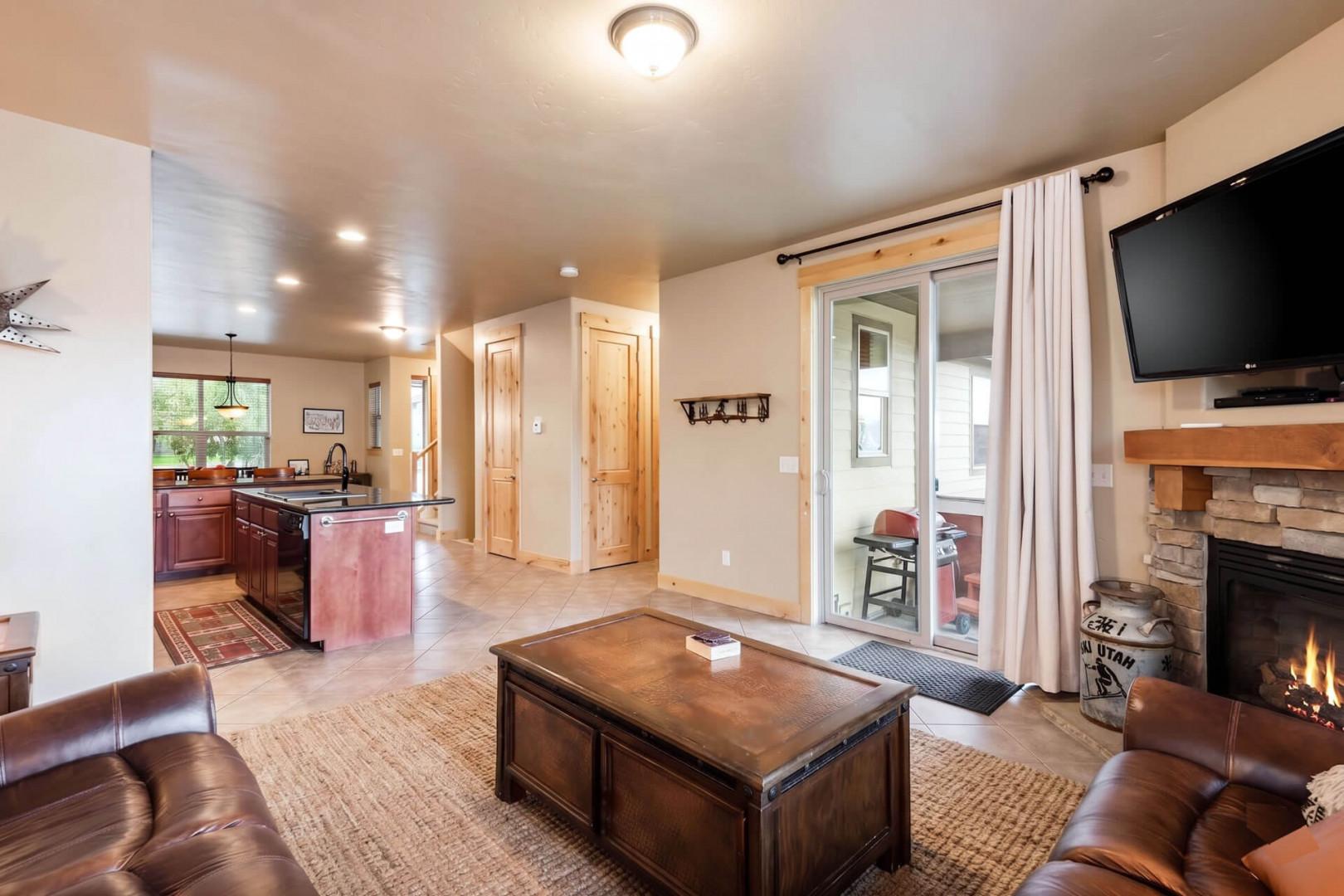 Unwind in your cozy retreat where a warm fireplace, comfortable seating, and an open kitchen invite you to relax and make yourself at home after a day of adventure.