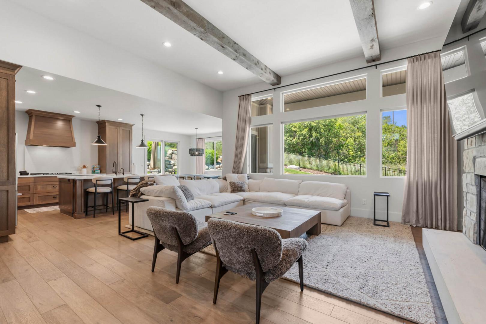 Relax in your bright, open-concept living space where rustic beams meet modern elegance. Sink into plush seating, cook in the chef's kitchen, and enjoy garden views through floor-to-ceiling windows.