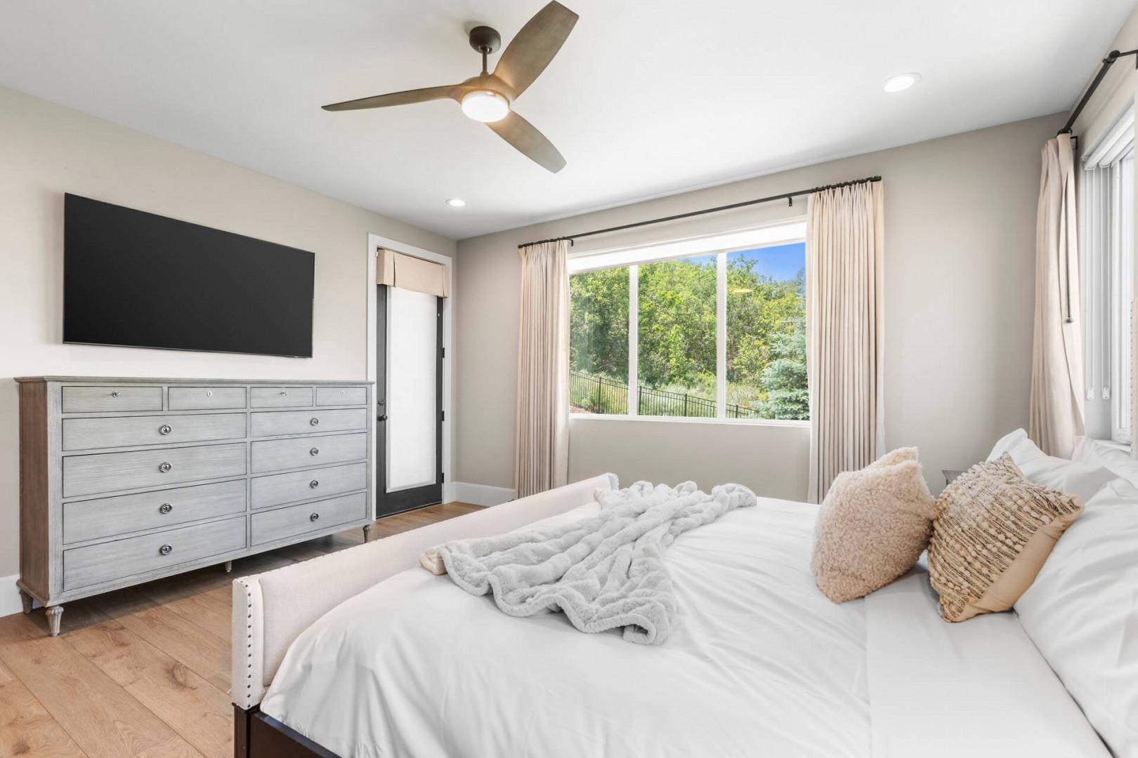Drift off in your bright, modern bedroom where soft neutral tones meet the lush garden views outside your window, promising restful mornings and peaceful nights.