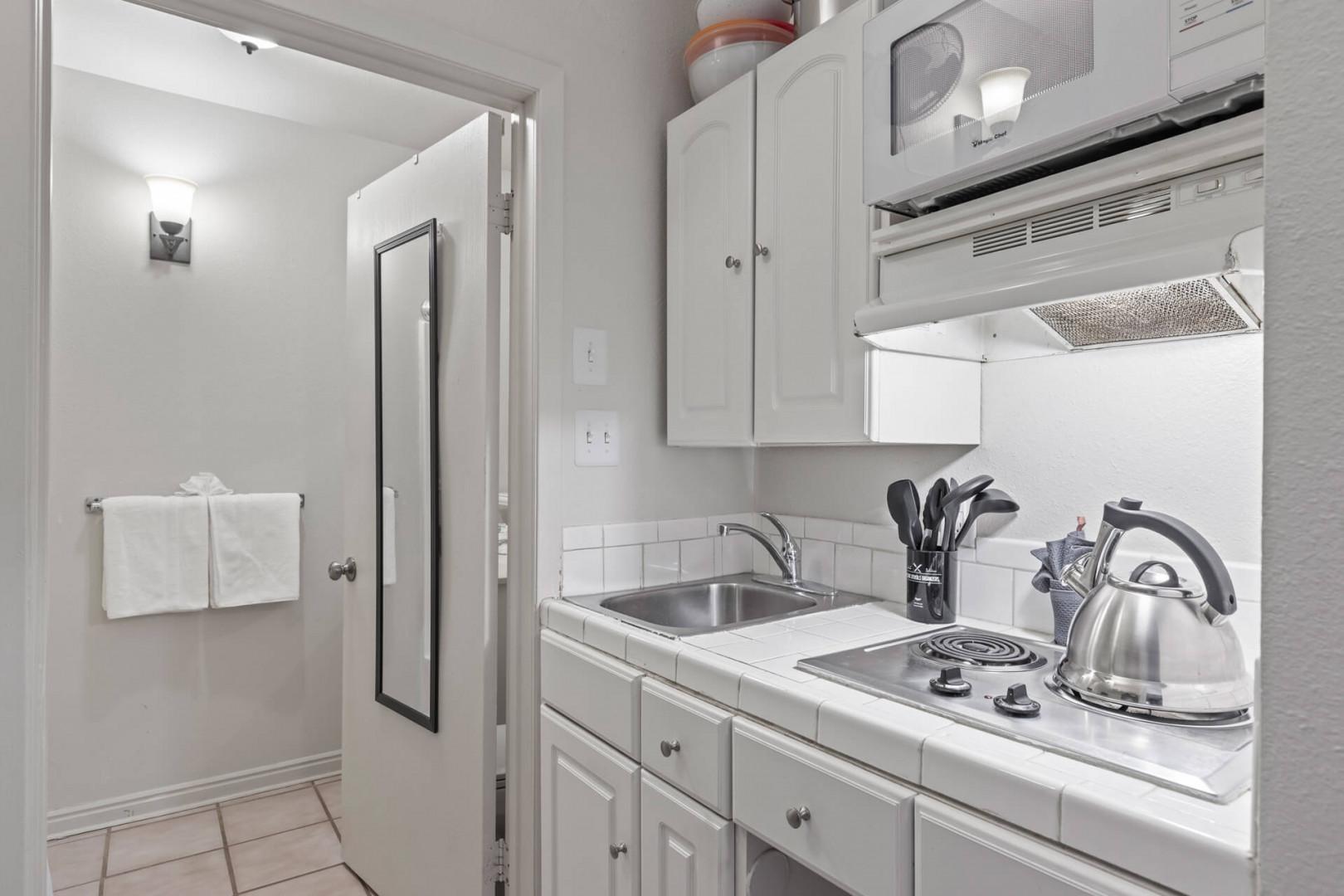 Modern appliances and ample storage in sleek kitchen design.