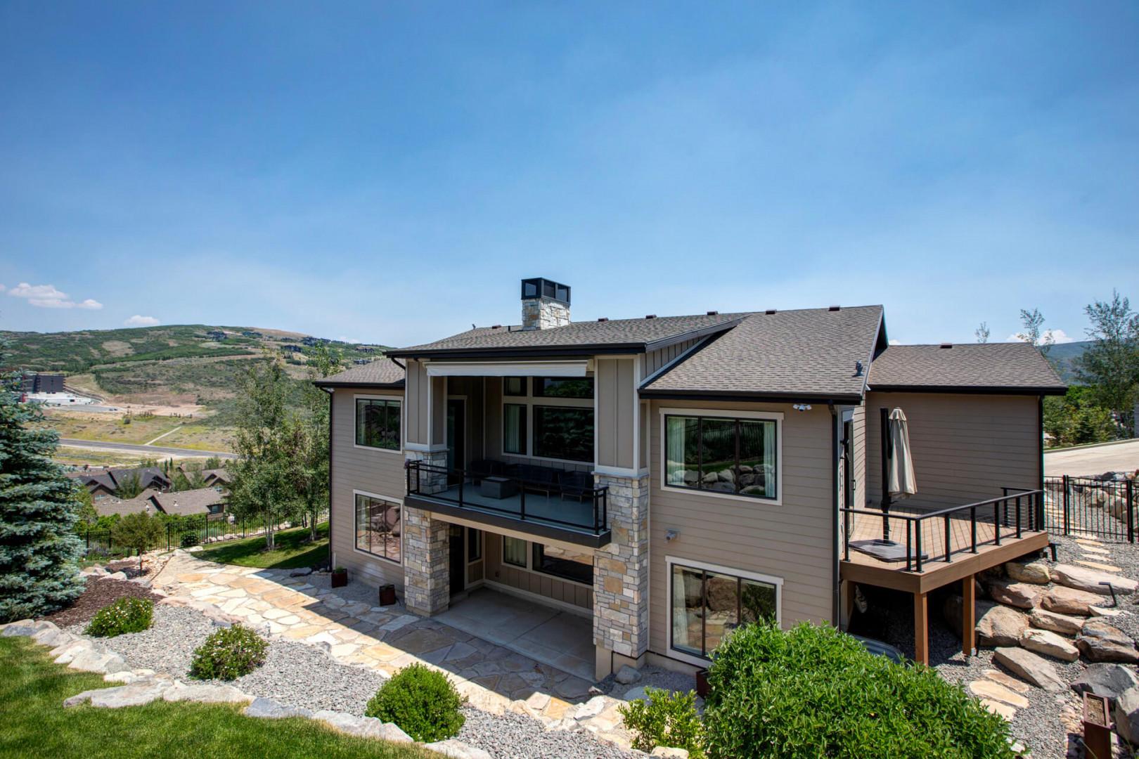 Spacious mountain retreat features modern architecture, multiple outdoor decks, and sprawling views of the surrounding valley and hillsides. The property is nestled in a scenic neighborhood with immediate access to natural landscapes.