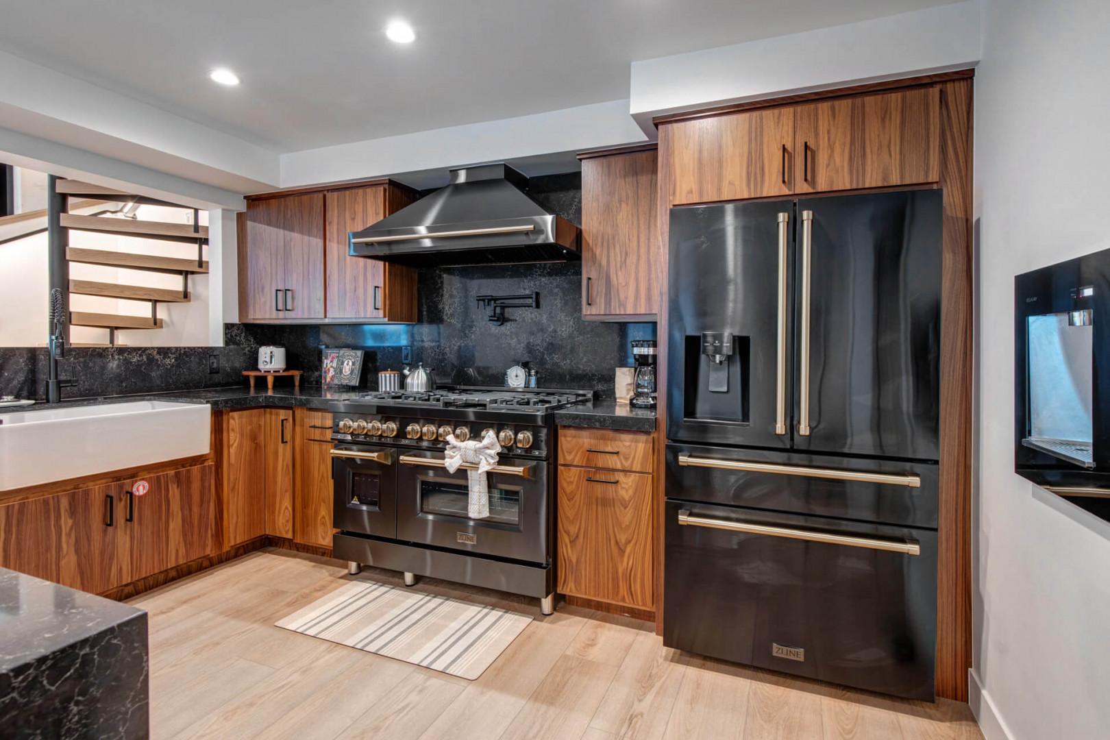 Upper Main 301: Cook your favorite meals in this sleek modern kitchen with premium stainless steel appliances, rich wood cabinetry, and elegant granite countertops.