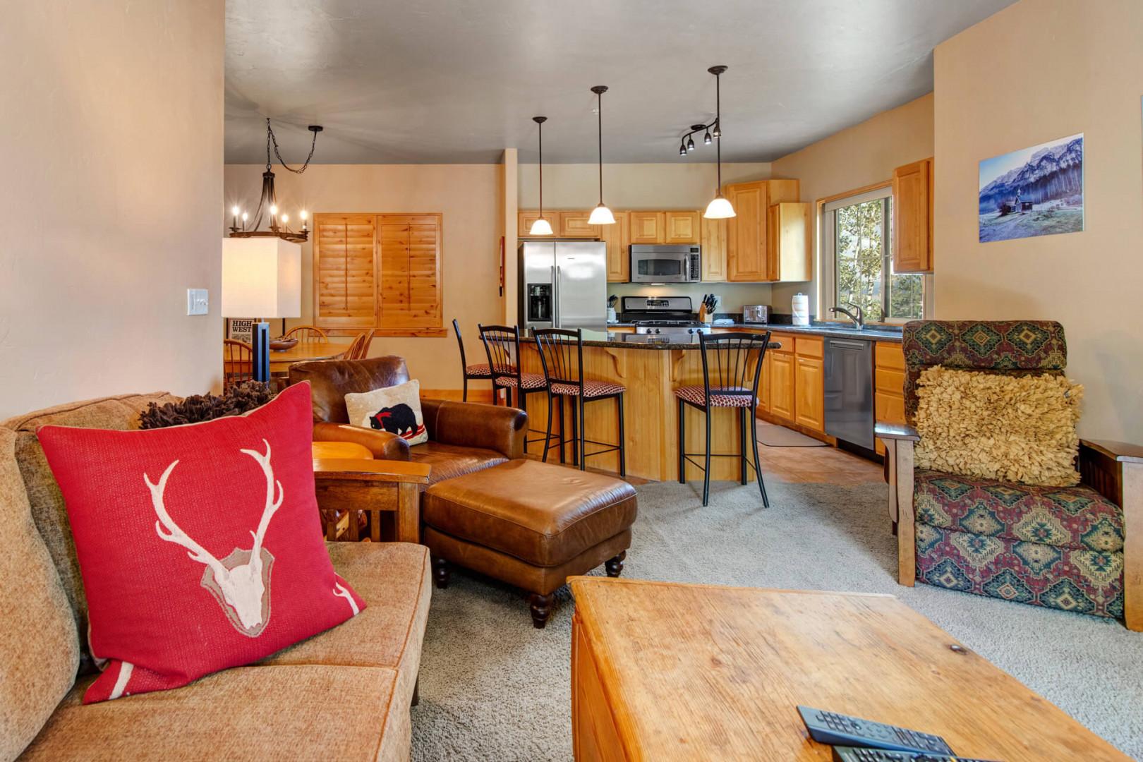 Your home away from home awaits with an open living space where warm wood tones and mountain touches create the perfect spot to relax after a day of adventure.